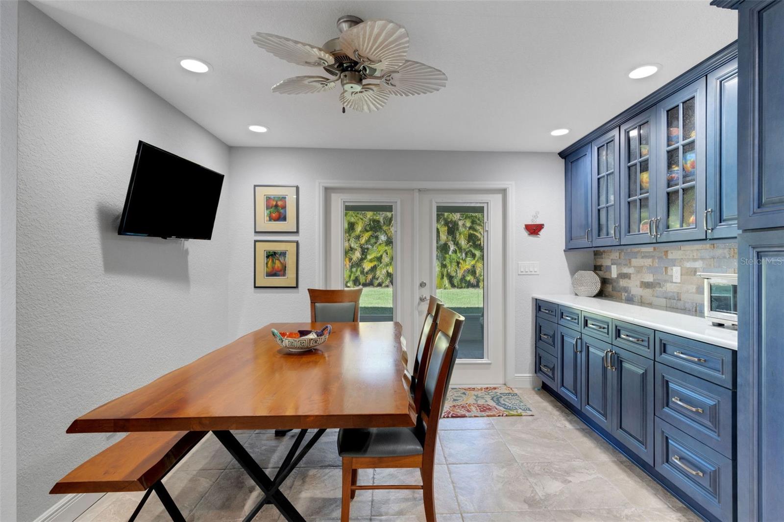 Double doors lead to back covered screen porch