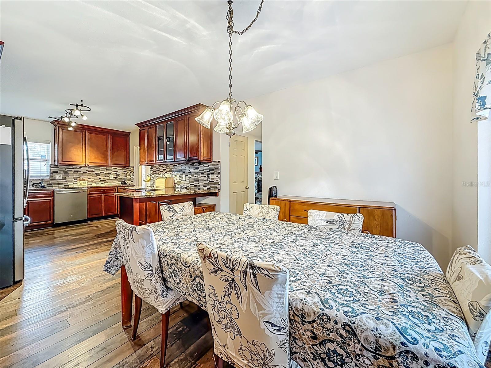 You are now in the dining room, which overlooks the kitchen. To your right are French doors leading to the backyard. Same update flooring in here, LVP.