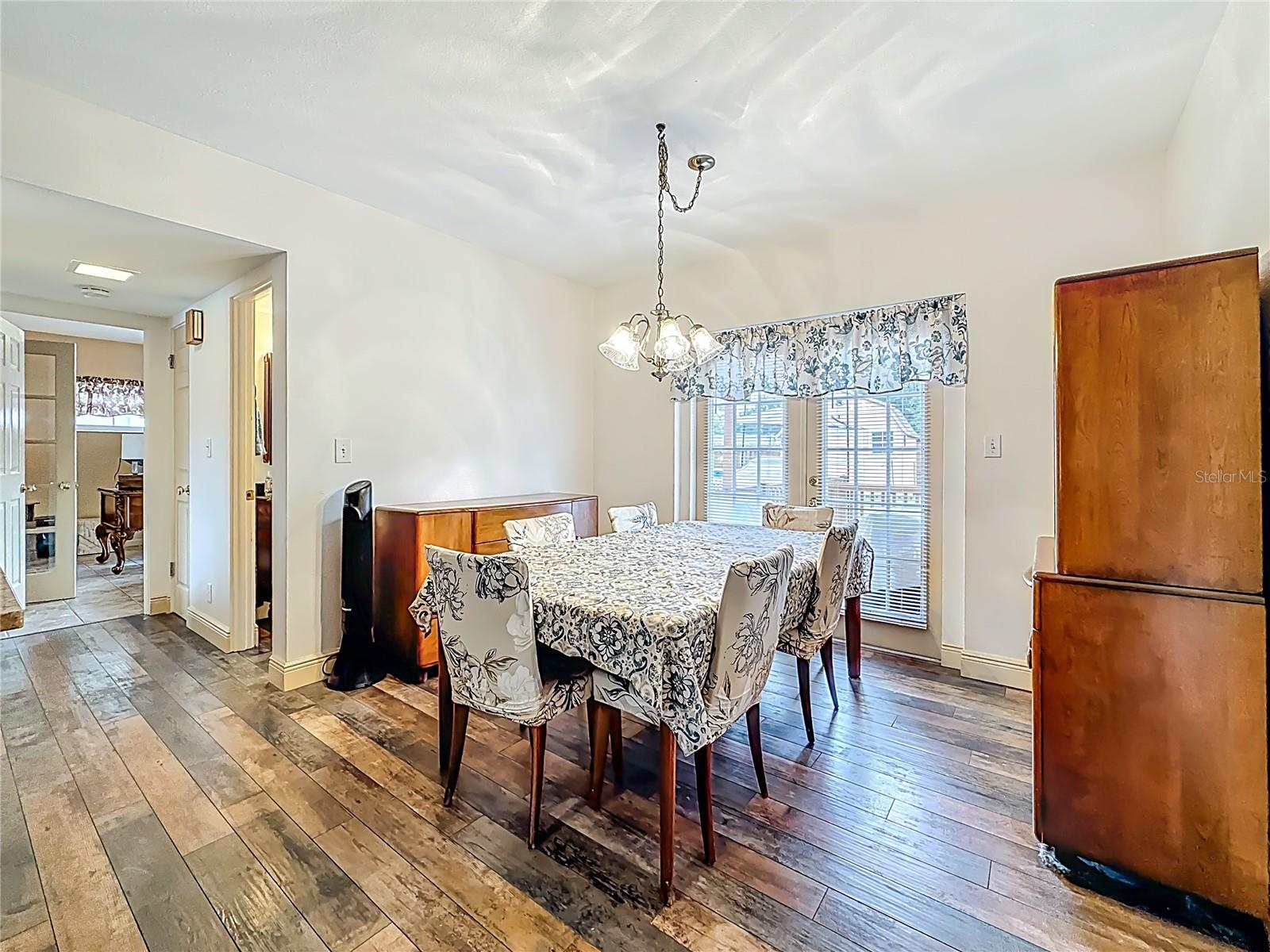In this view of the dining room, the French doors leading to the back yard are visible, as well as the entrance to the half bath door and the doorway into the 4th bedroom. Behind you is the door leading into the garage