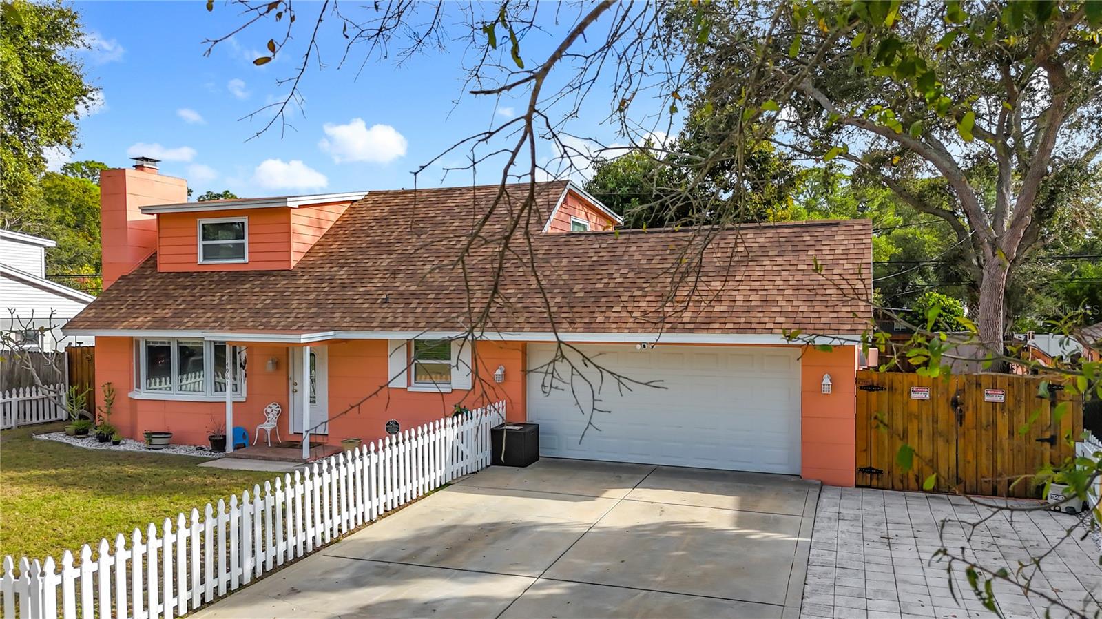 Lower level is block construction. Upper level is wood frame. Cute white picket fence around the front yard.