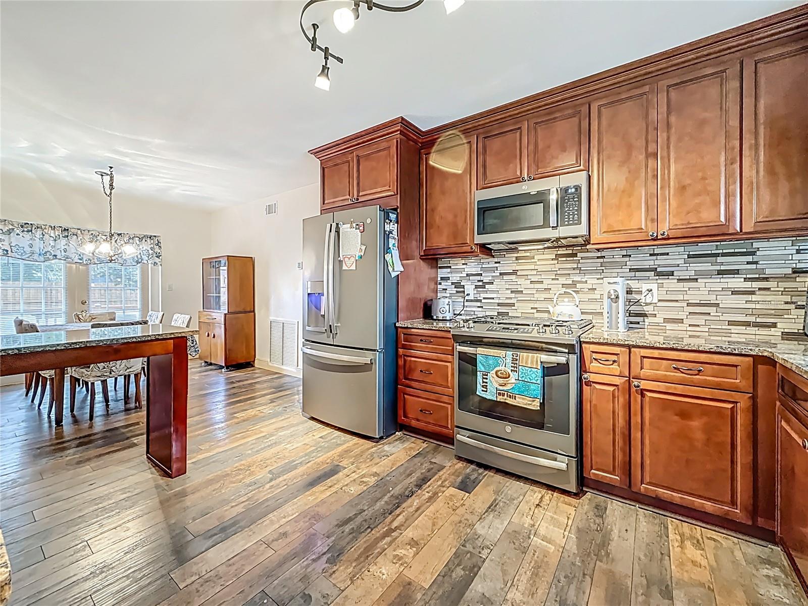 Behind you is the dishwasher, view back towards the breakfast bar & dining room. TONS of cabinets :-)