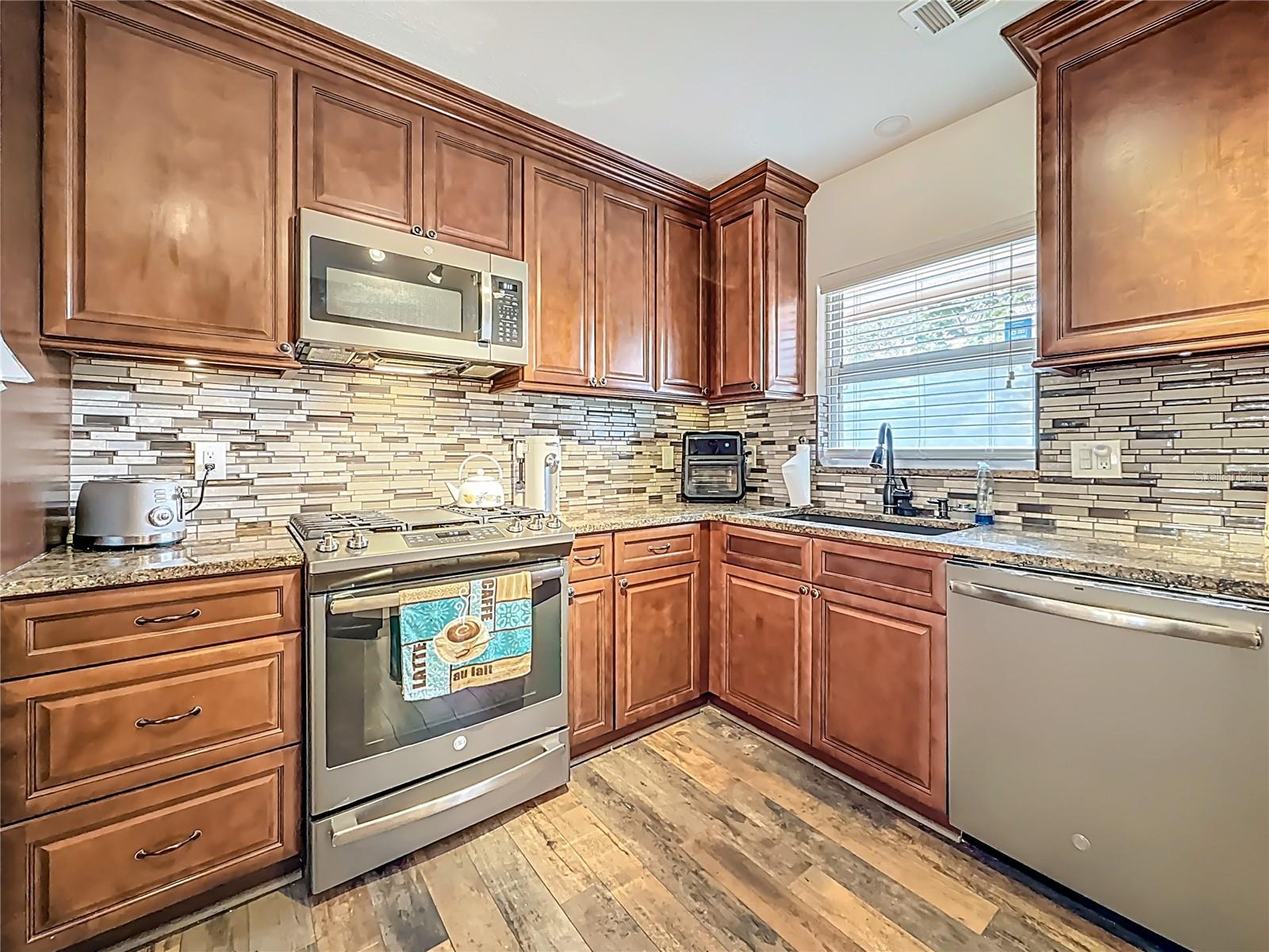 Closer view of the gas range. Ample granite counter space, too.