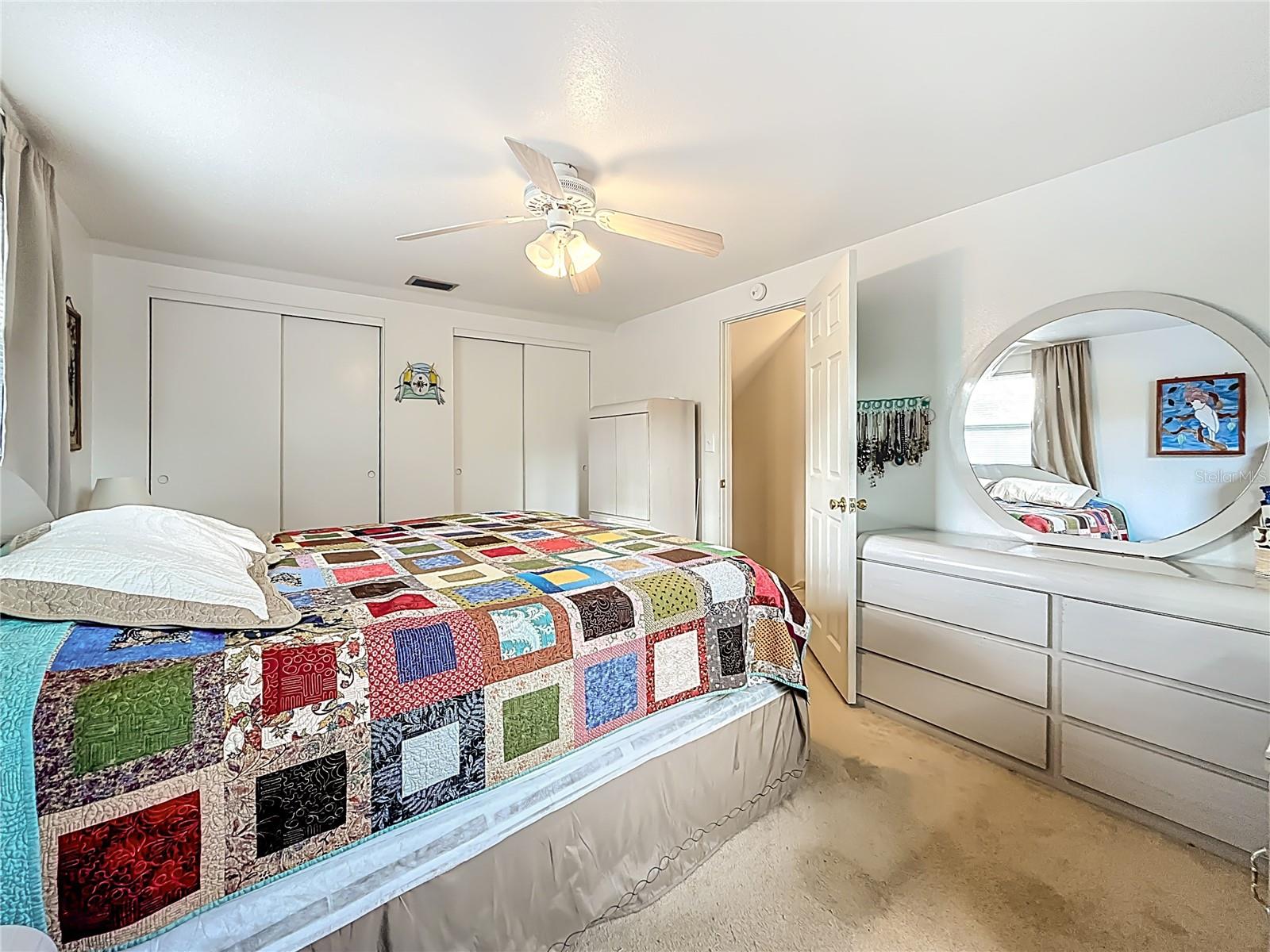 You are still in the largest of the 3 upstairs bedrooms. In this view, wide wall to wall closet is visible along with the entrance door.