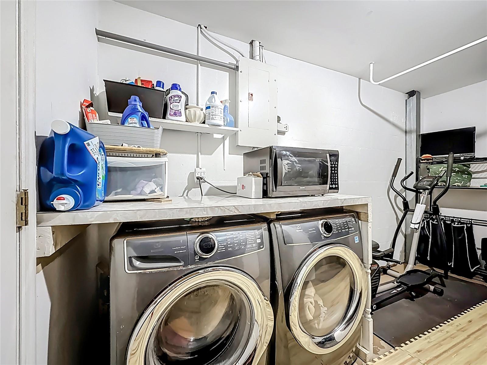 Laundry room with flex space in the garage. The Electrolux Washer & Dryer ( 2019) convey.