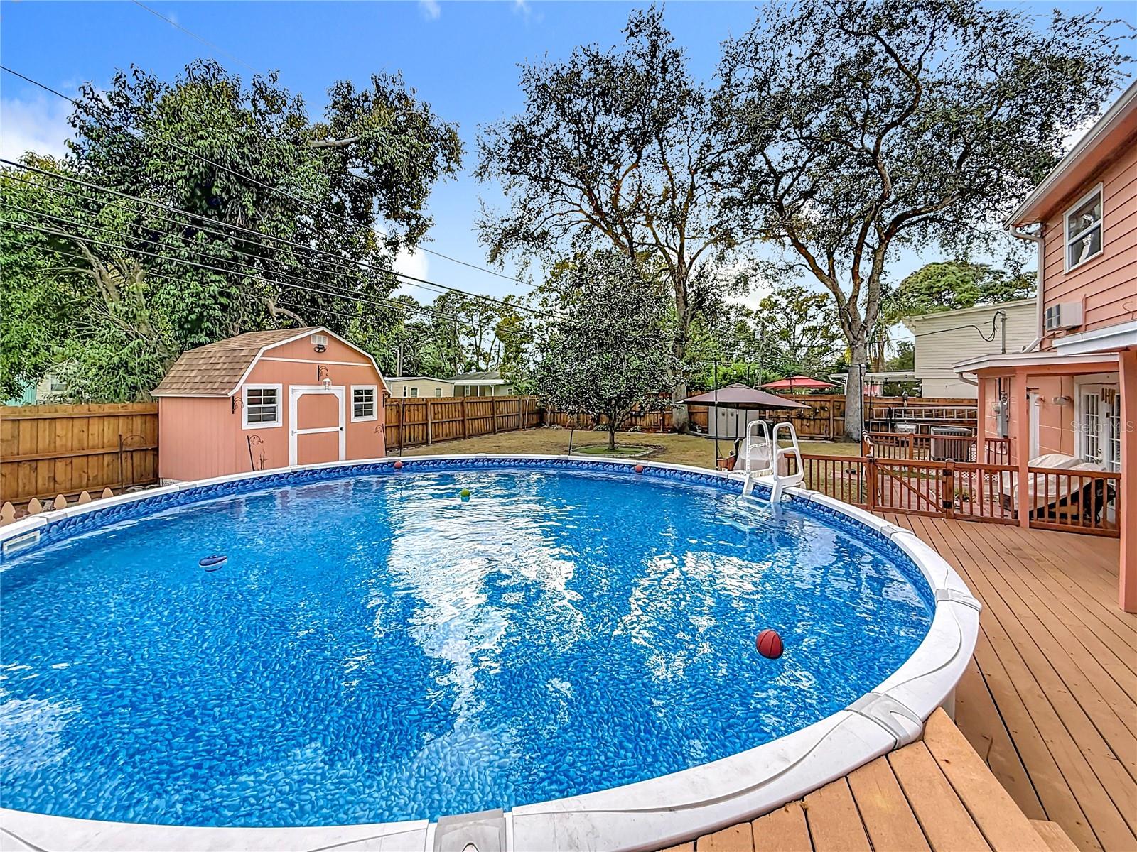 Long view of the yard beyond the pool.