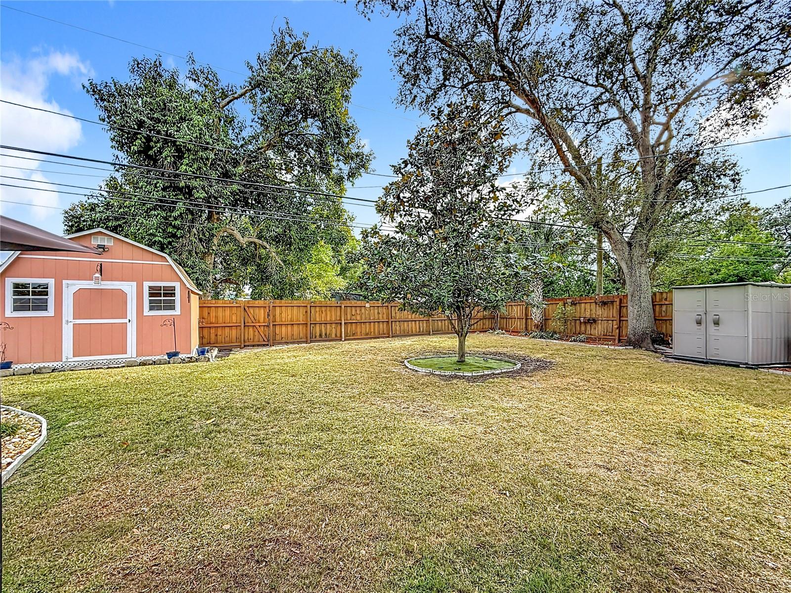 Great shed (currently used for storage) which includes a loft inside. The wood fence was replaced in 2019. BUT, please take note of the pedestrian gate (within the fence) next to the shed. THAT leads you to the edge of  Long Branch Creek. Bring out a couple chairs, some drinks and sit & enjoy the tranquility of mother nature. You will feel like you are in another space in time. PEACEFUL is the best word to describe it. Yes, the shed on the right side conveys, as well.