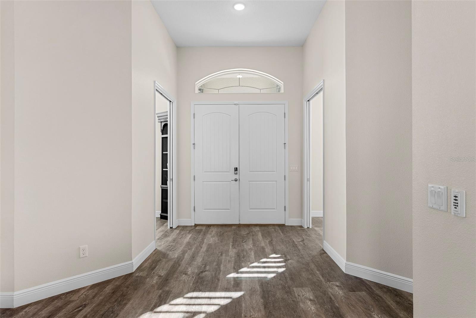 Foyer Bright and welcoming, the entryway features double doors, transom window, and durable wood-look flooring that continues throughout the home.
