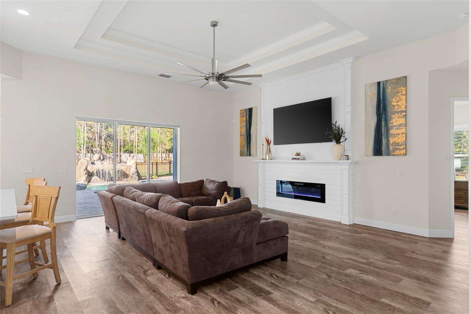 Living Room A clear view of the front entry and fireplace showcases the thoughtful layout and flow of this elegant living space