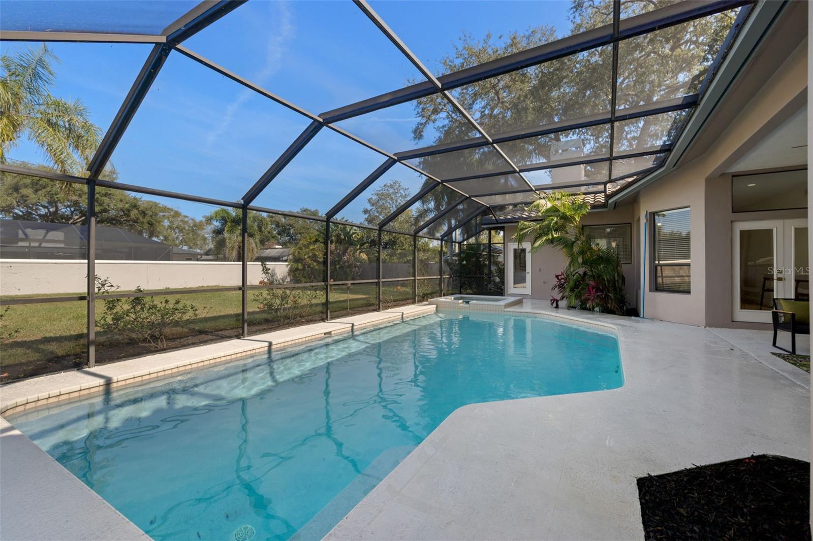 rear door leads to a dedicated pool half bath