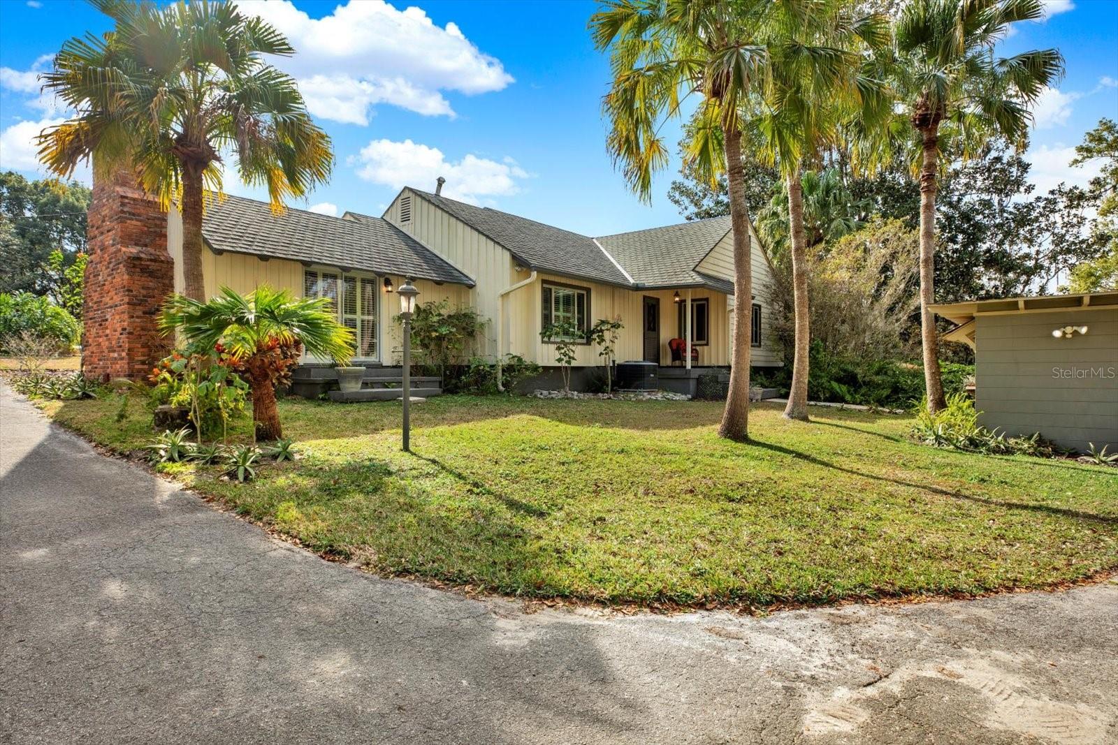 Back of House and winding driveway to carport