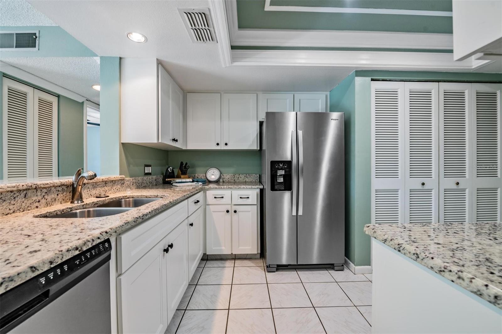 Beautiful updated kitchen with granite counters, abundance of cabinets, stainless appliances and coffered ceiling