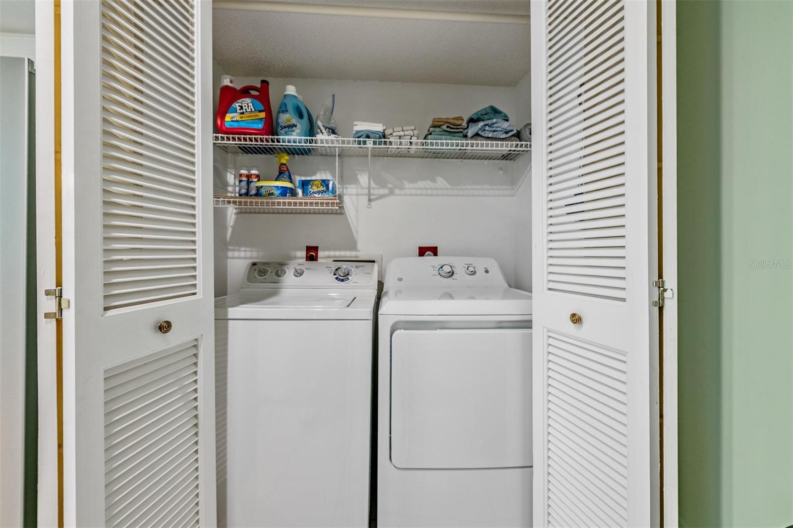 Laundry closet inside the kitchen with washer and dryer included