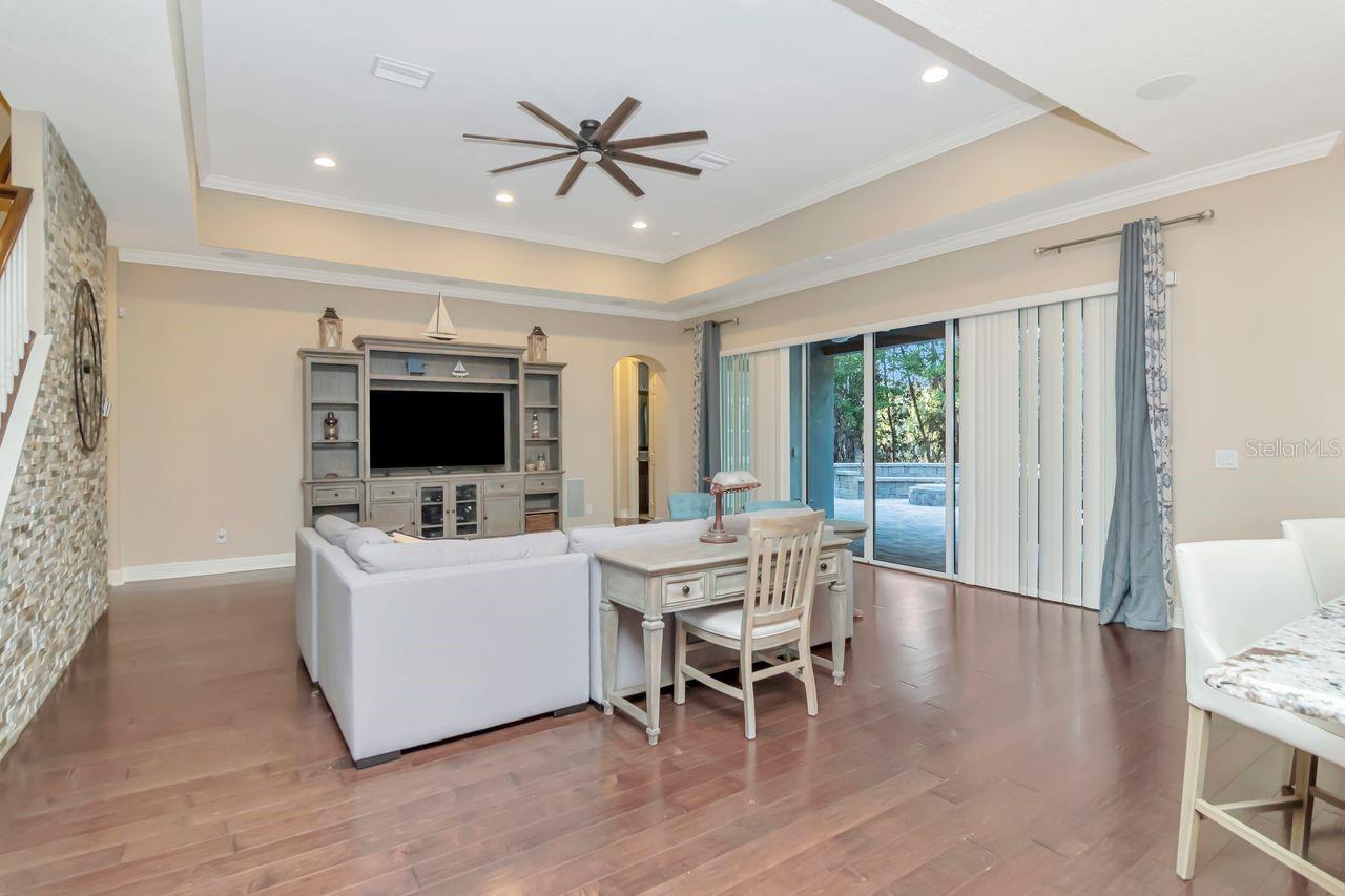 Spacious Grand Room Featuring Elegant Tray Ceiling