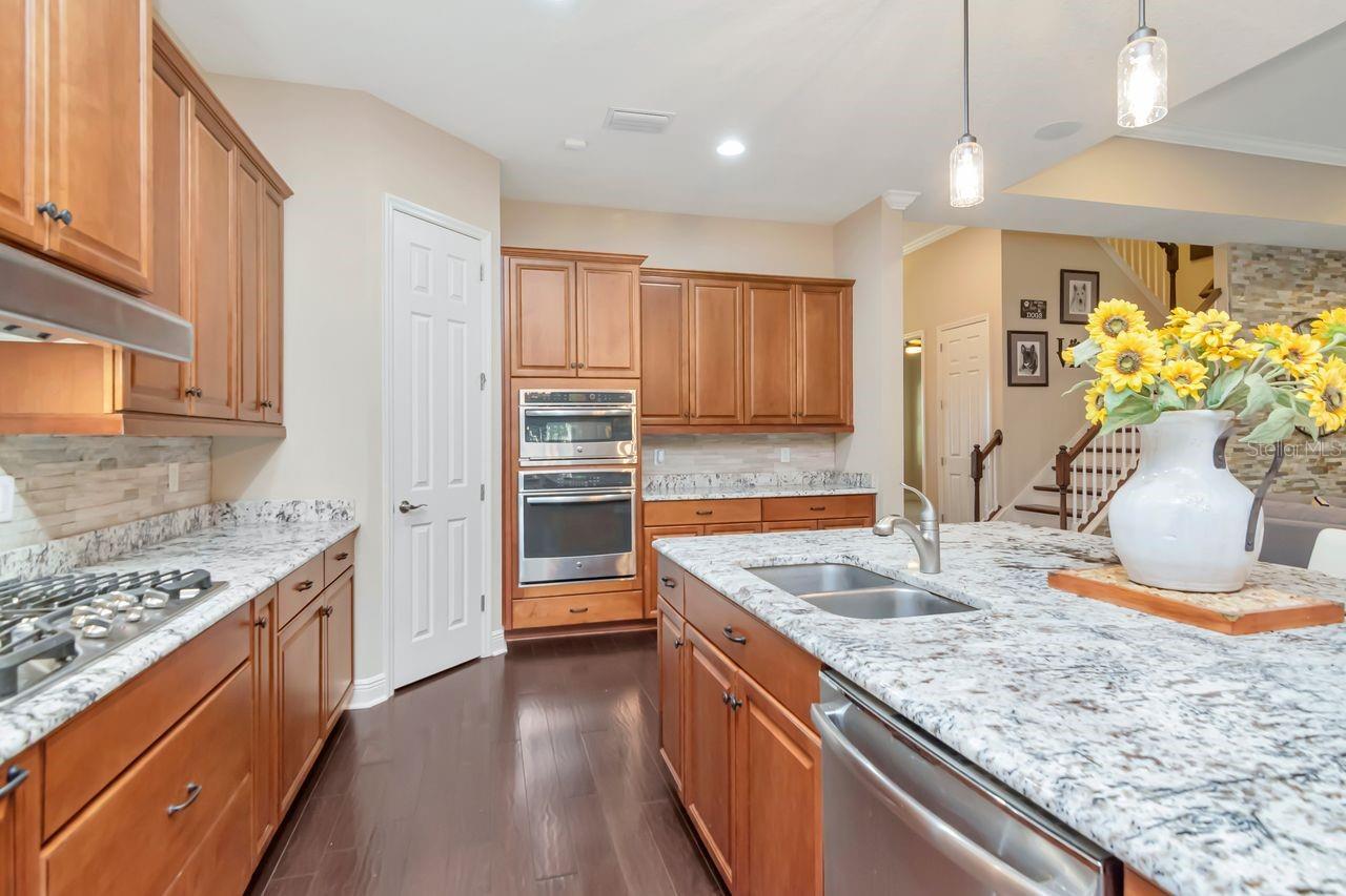 Gourmet Kitchen Featuring Double Ovens and a Gas/Electric Cooktop