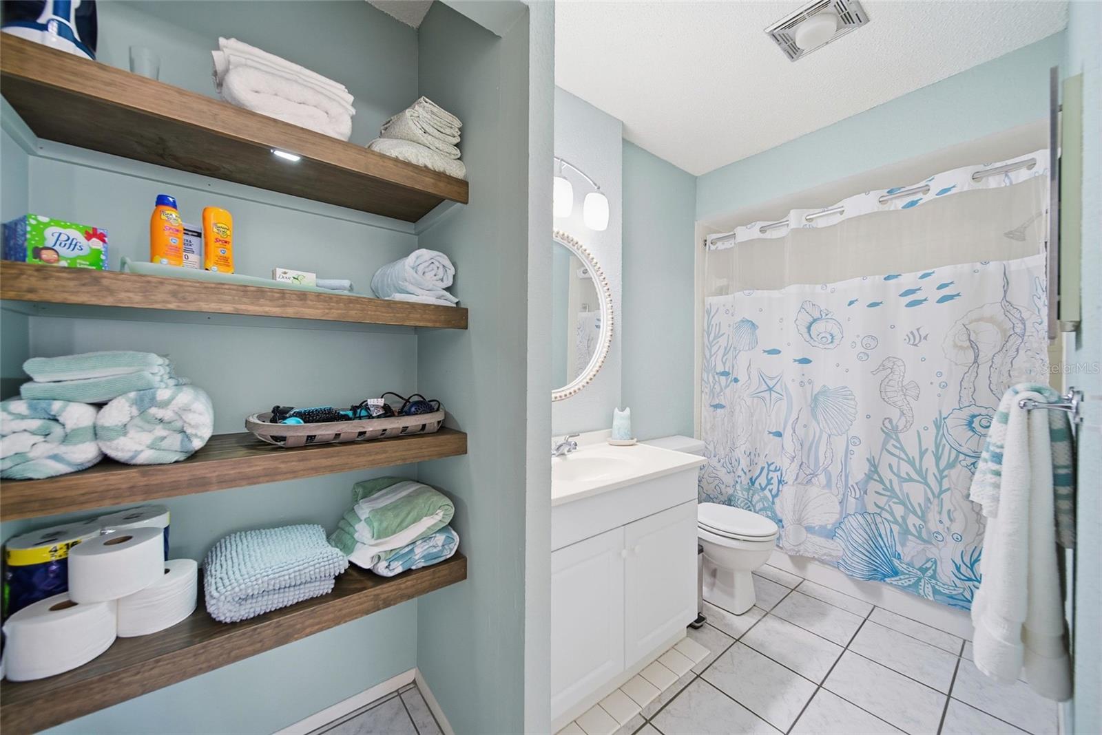 Bathroom linen closet with custom made shelving.