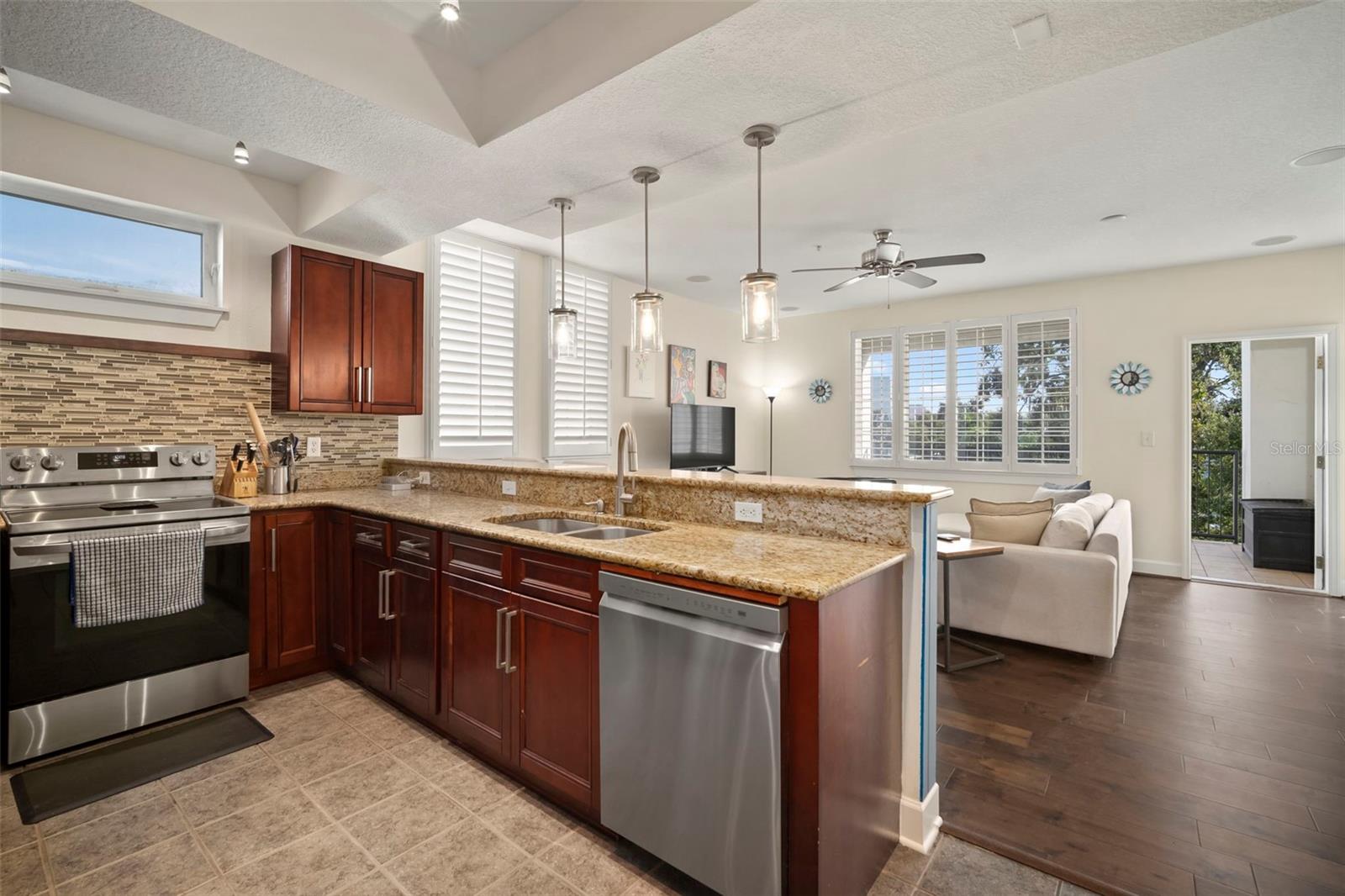 Kitchen looking to great room and open door the balcony with incredible city views.