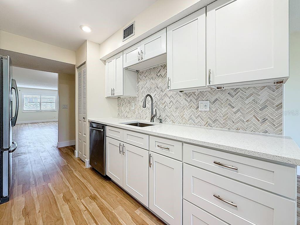 Kitchen stainless appliances, quarts counter tops and Italian marble backsplash.