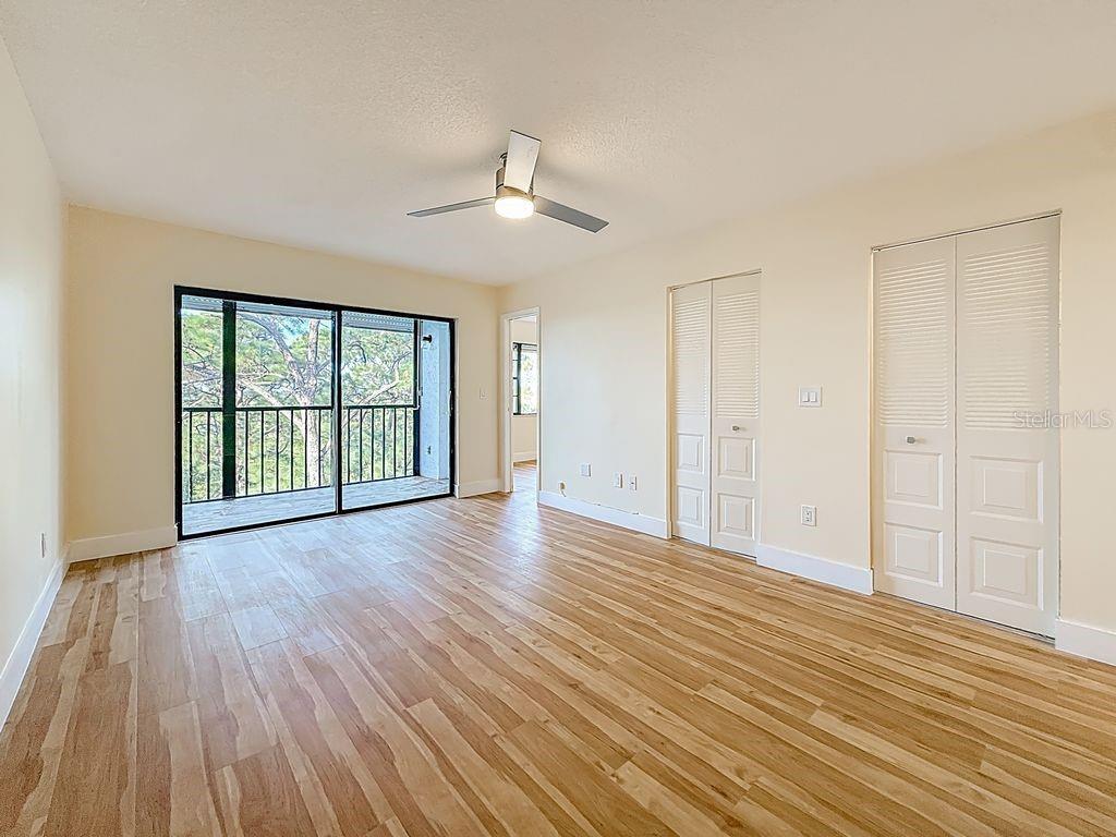 Primary bedroom has sliders to the screened lanai.