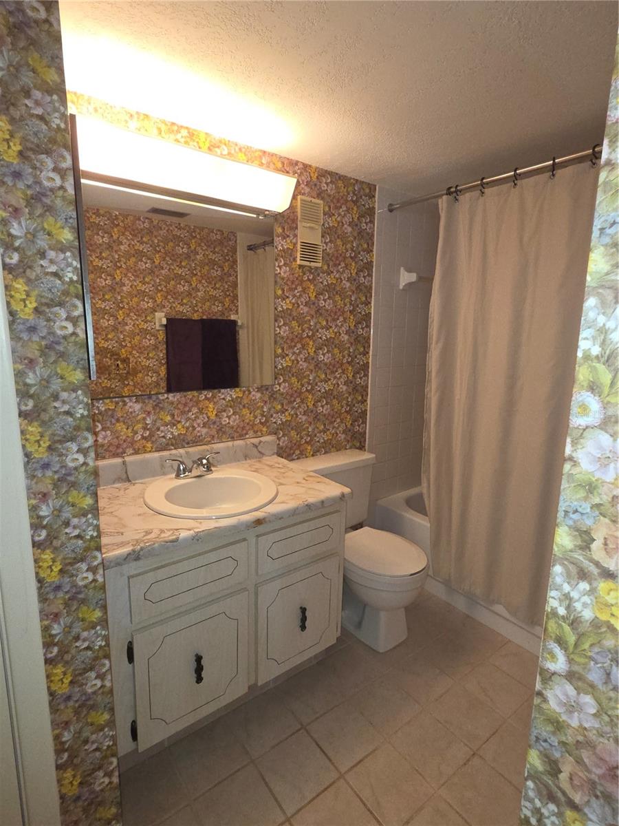 Guest bathroom has a tub-shower combo