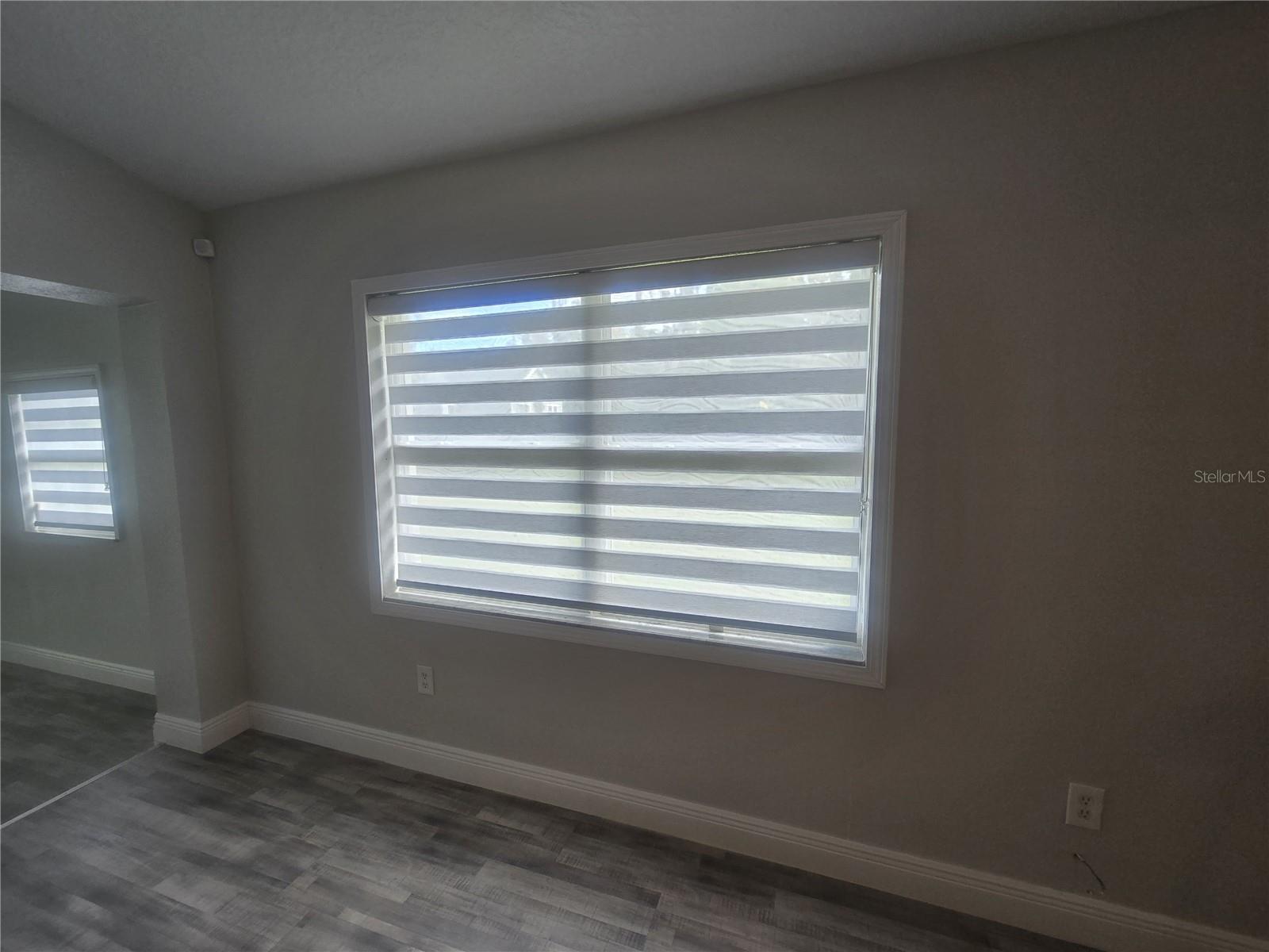 Window treatments in living room, dining room and kitchen