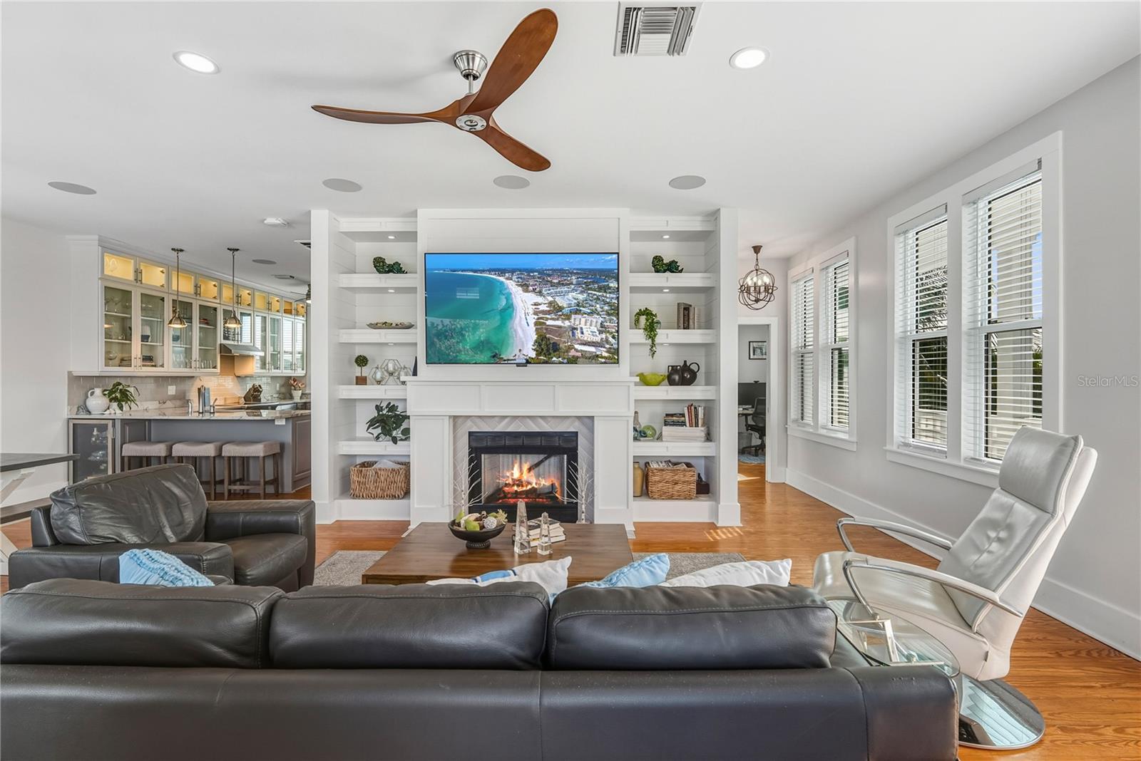 Light-filled great room with seamless indoor/outdoor flow , fireplace and multiple doors to wrap around balconies.