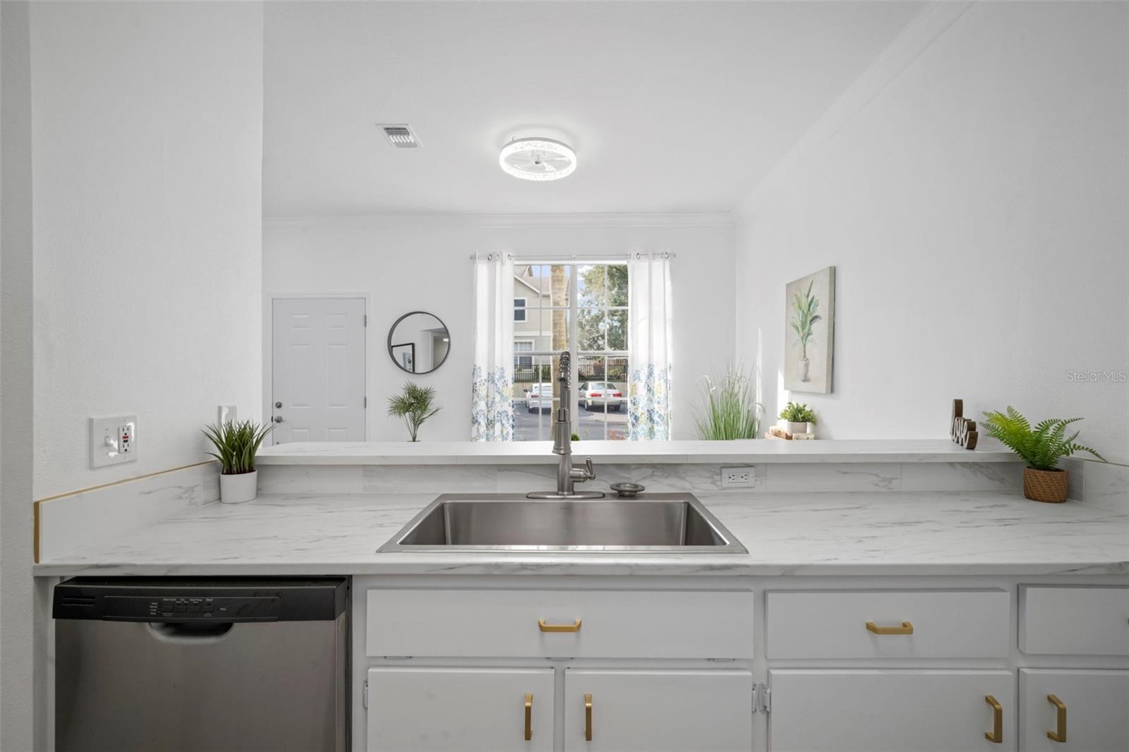 Sink overlooks dining area making dinner prep easy.