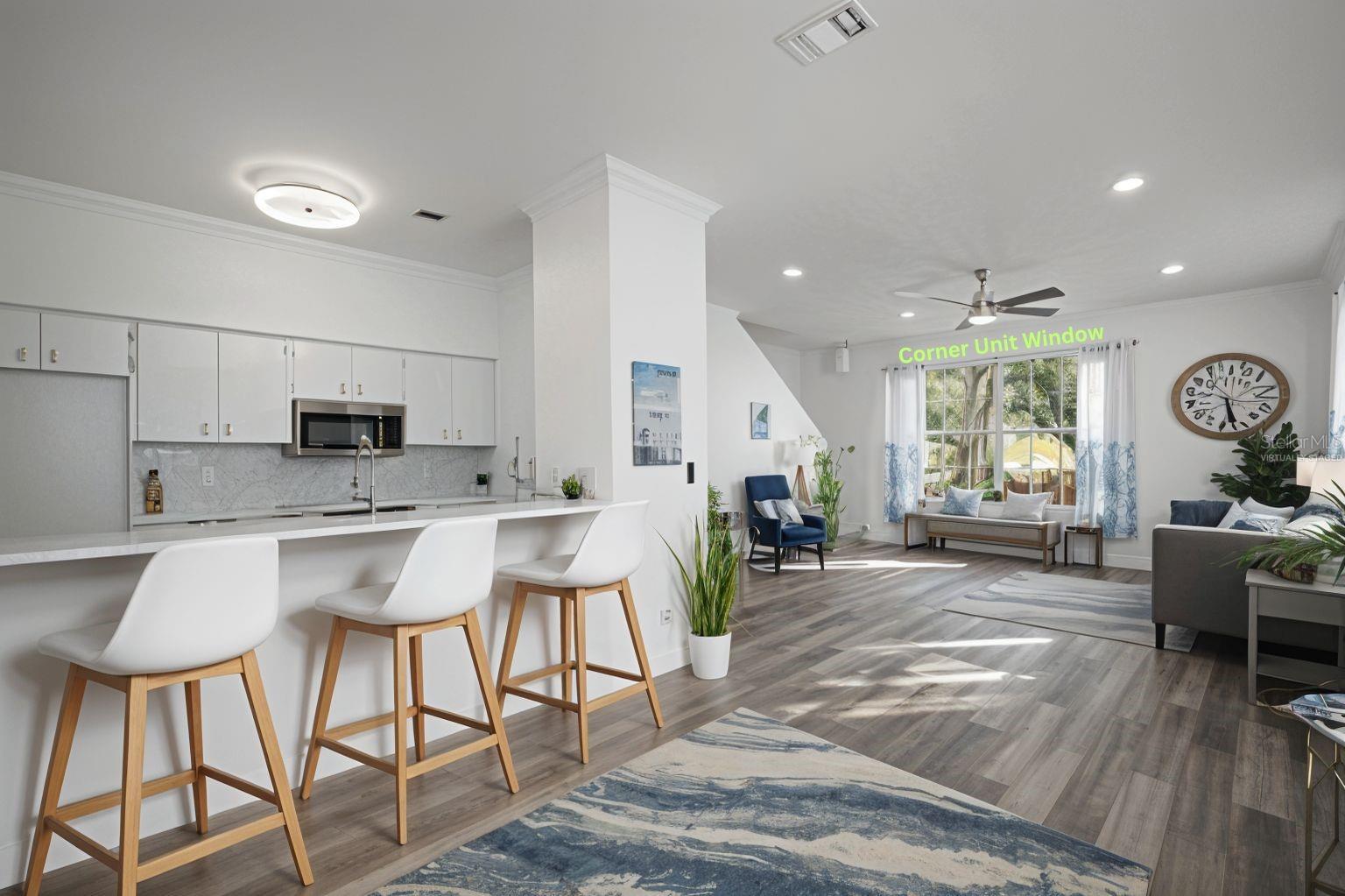 View from Dining are overlooking living room and kitchen is to the right. Bar top can accommodate 5 bar stools. Bar stool "Virtually staged".