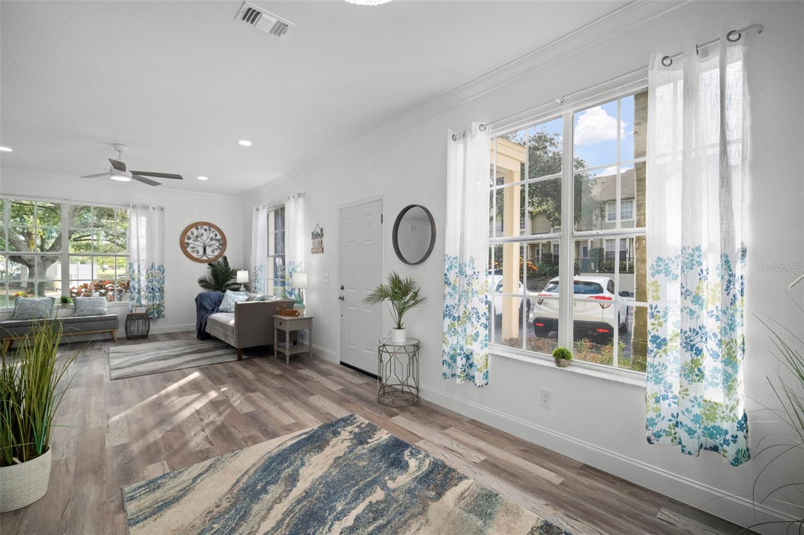 View from Dining are overlooking living room towards the front door. Your "parking spot" is conveniently located in front of your living room window (right behind the couch).