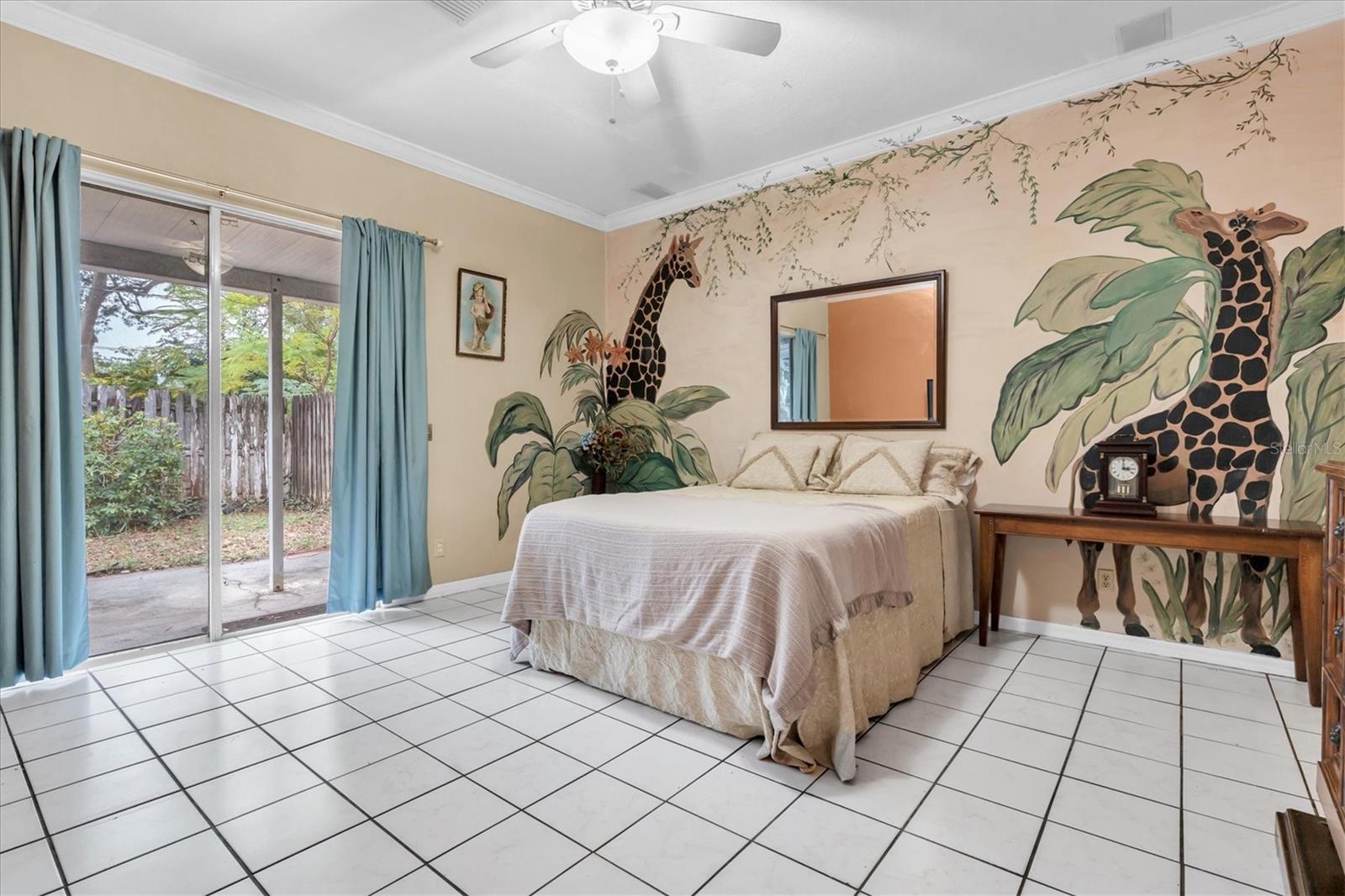 Master Bedroom with unique animal murals. Sliding glass doors exit out to a covered porch area.