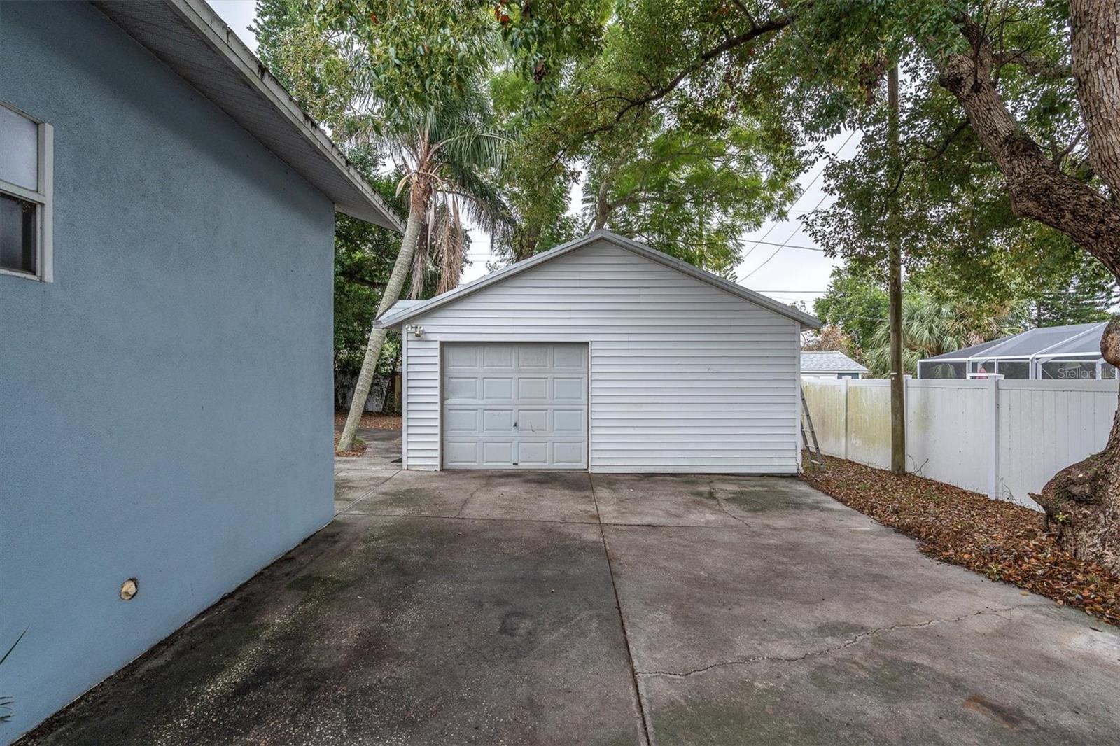 Large (21x20 sq ft) garge with lots... of room for parking all those toys beyond the gated fence. Roof recently replaced on the garage.