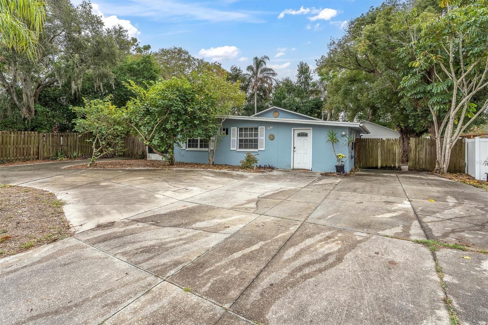 Tons of parking space! And to the right of the home is a double gated fence which allows access into the back yard  for more parking and has a RV electric hook up.