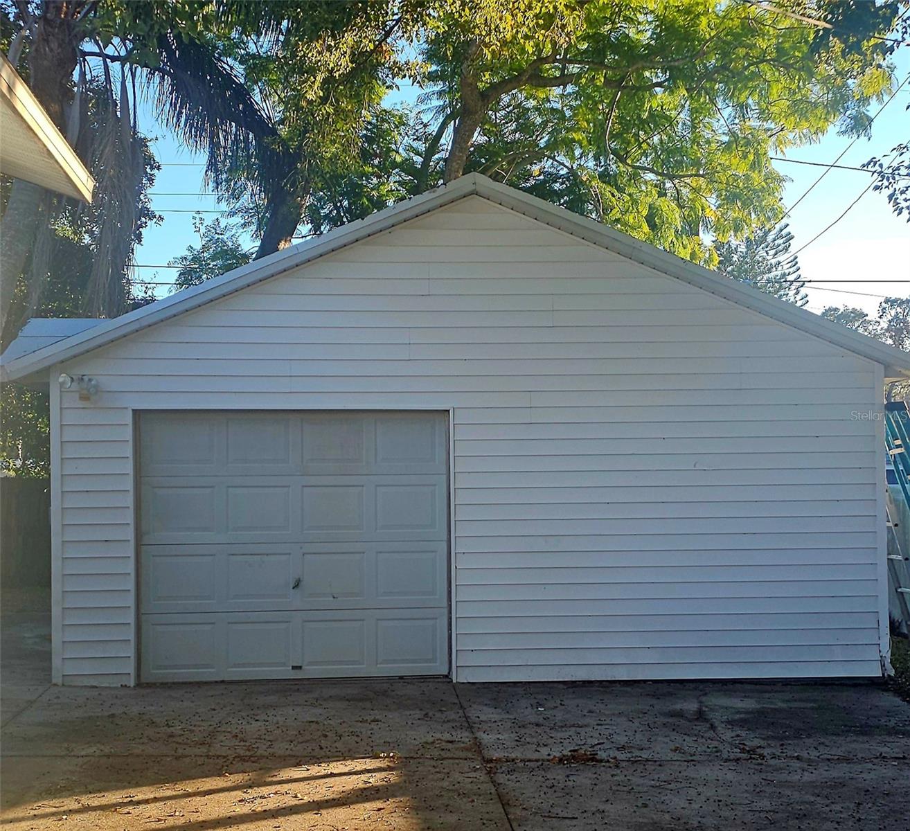 Large (21x20 sq ft) garge with lots... of room for parking all those toys beyond the gated fence. Roof recently replaced on the garage.
