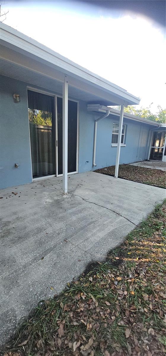 East side of home. Covered porch outside the master bedroom and further to the fron is a enclosed screened in porch that leads to the livingroom.