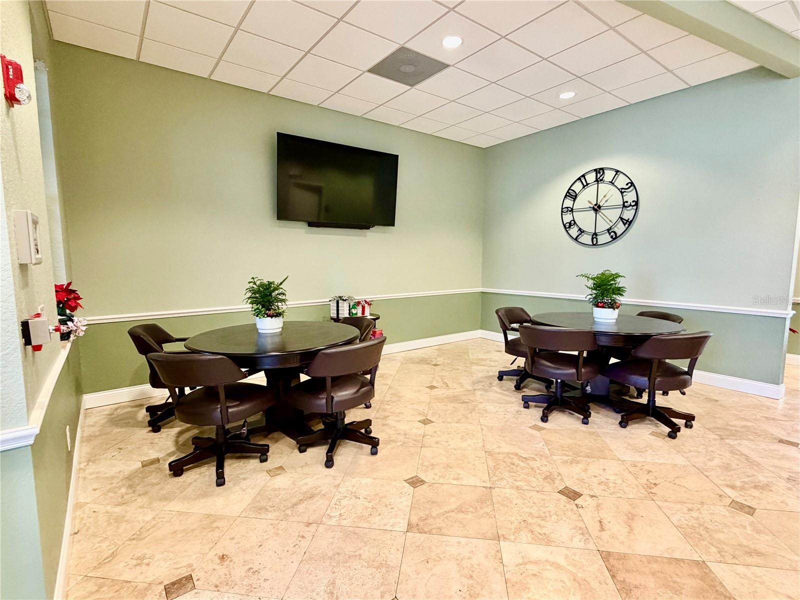 Spacious community lounge with pool table and gathering space.