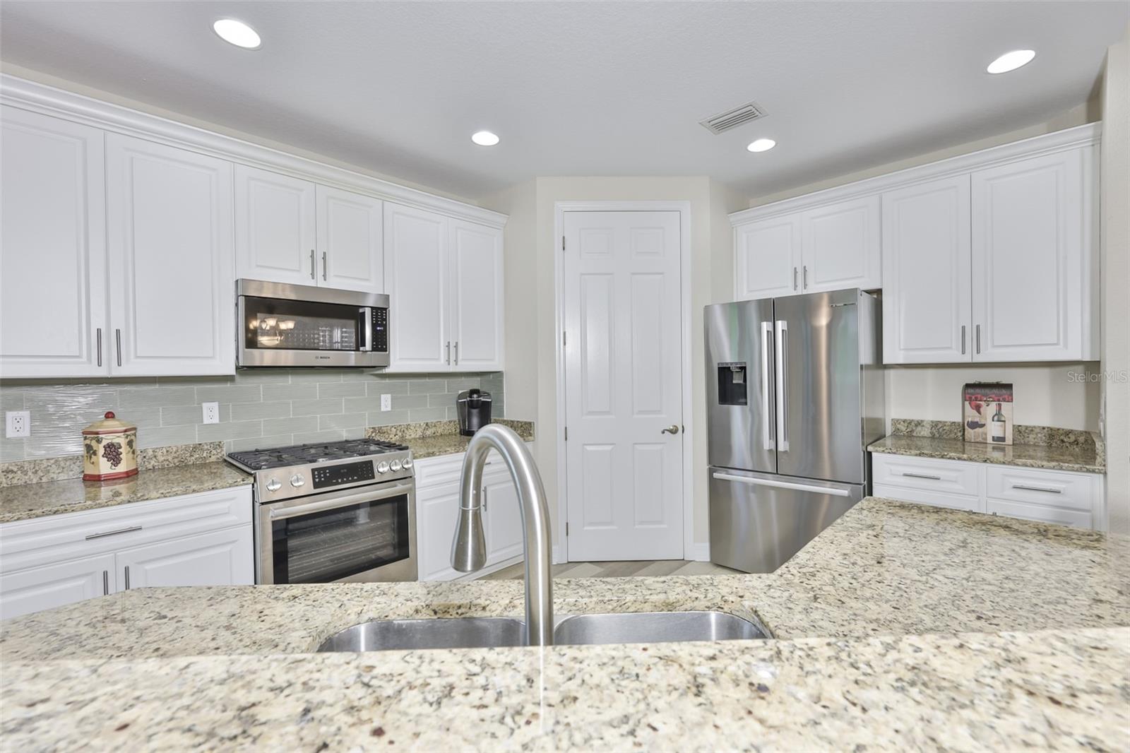 Bright white cabinetry, walk in pantry and LOTS of counterspace make this a dream kitchen.