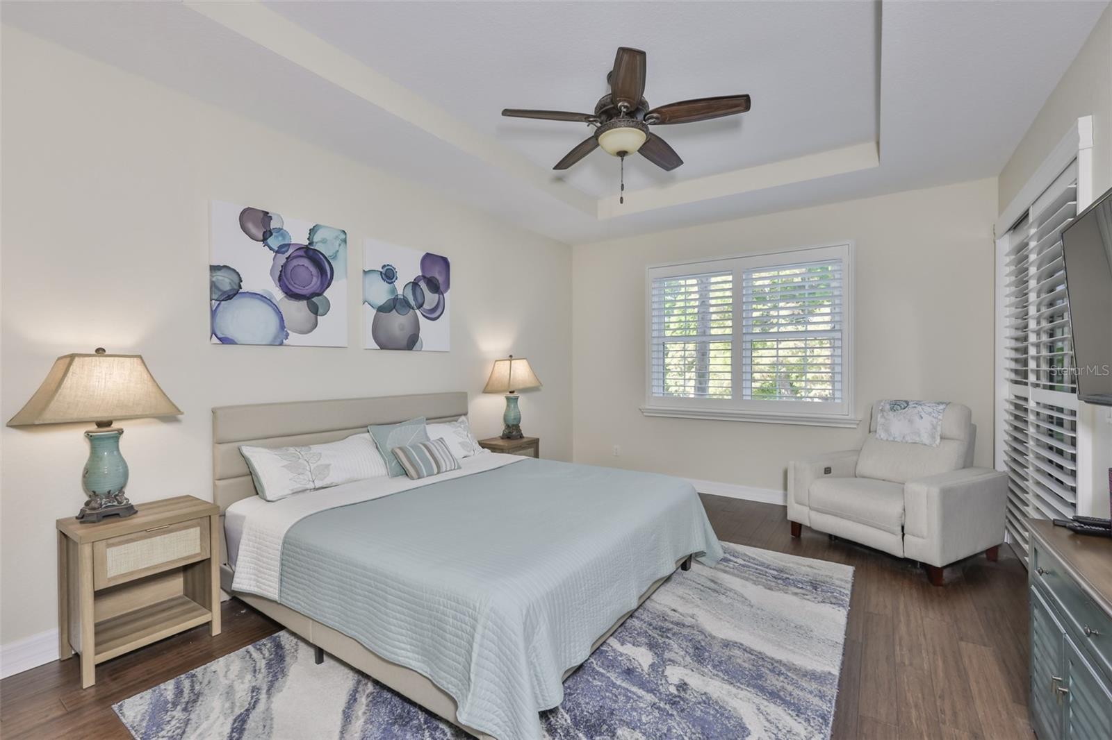 The owners suite is large with Acai hardwood flooring, plantation shutters and large windows for lots of Florida sunshine to flow into the room.