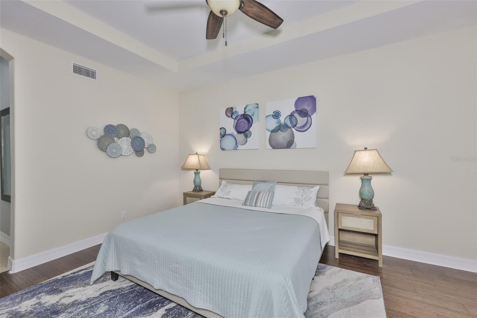 Clean, modern paint tones, King size bead and plenty of room for additional furniture, compliment the room nicely.