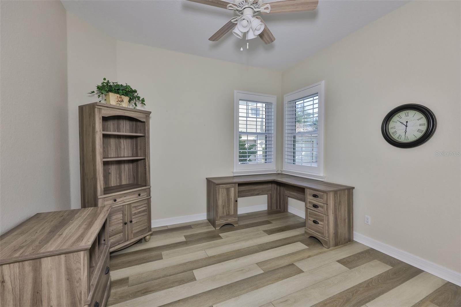 Second bedroom is setup as an office.  The corner window unit provides a lot of natural light and a wonderful few of the brick parking pad and tree lined street.