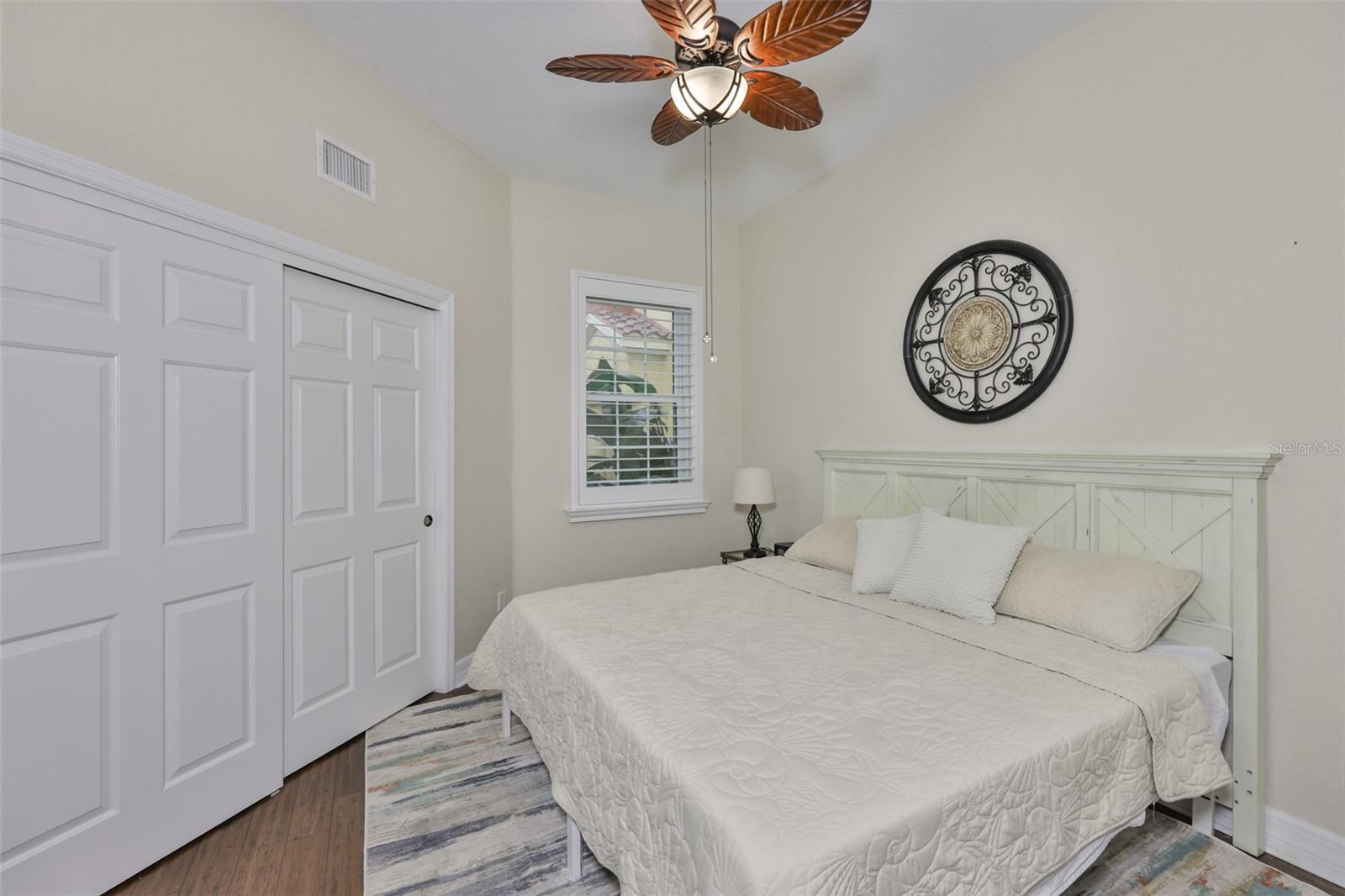 A plantation shuttered, hurricane impact window looks over a private courtyard for a peaceful and private view of the world.