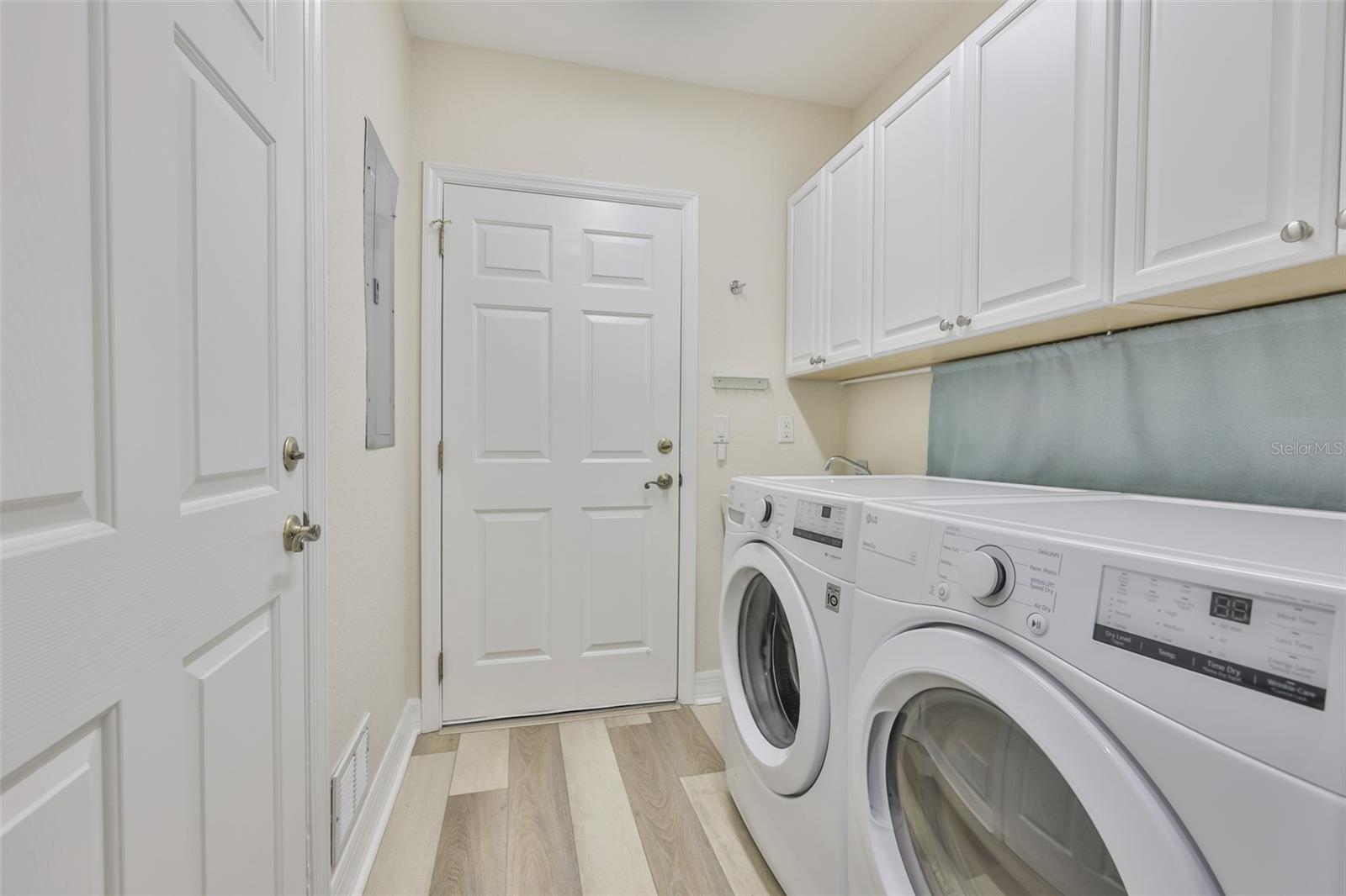 The laundry room leads into the two car garage.  It boasts of newer washer and dryer appliances, a full size utility sink and lots of storage.