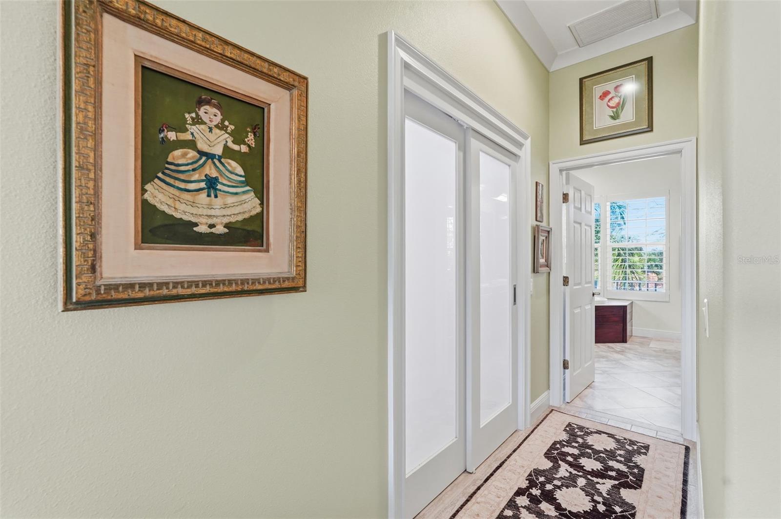 Hallway to master bathroom. Beautiful closet doors.