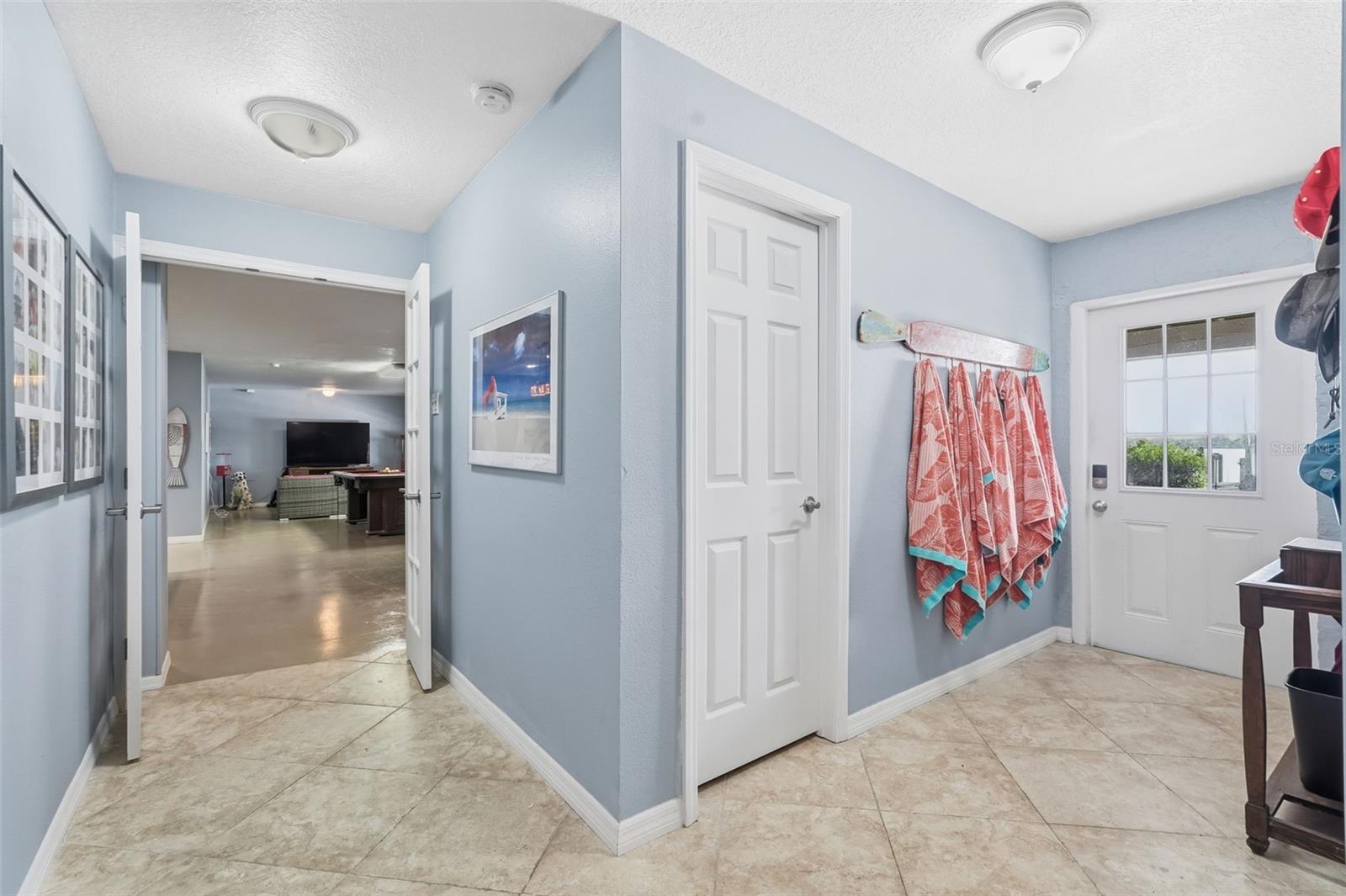 Downstairs, door to outside, storage, and entrance to gameroom.