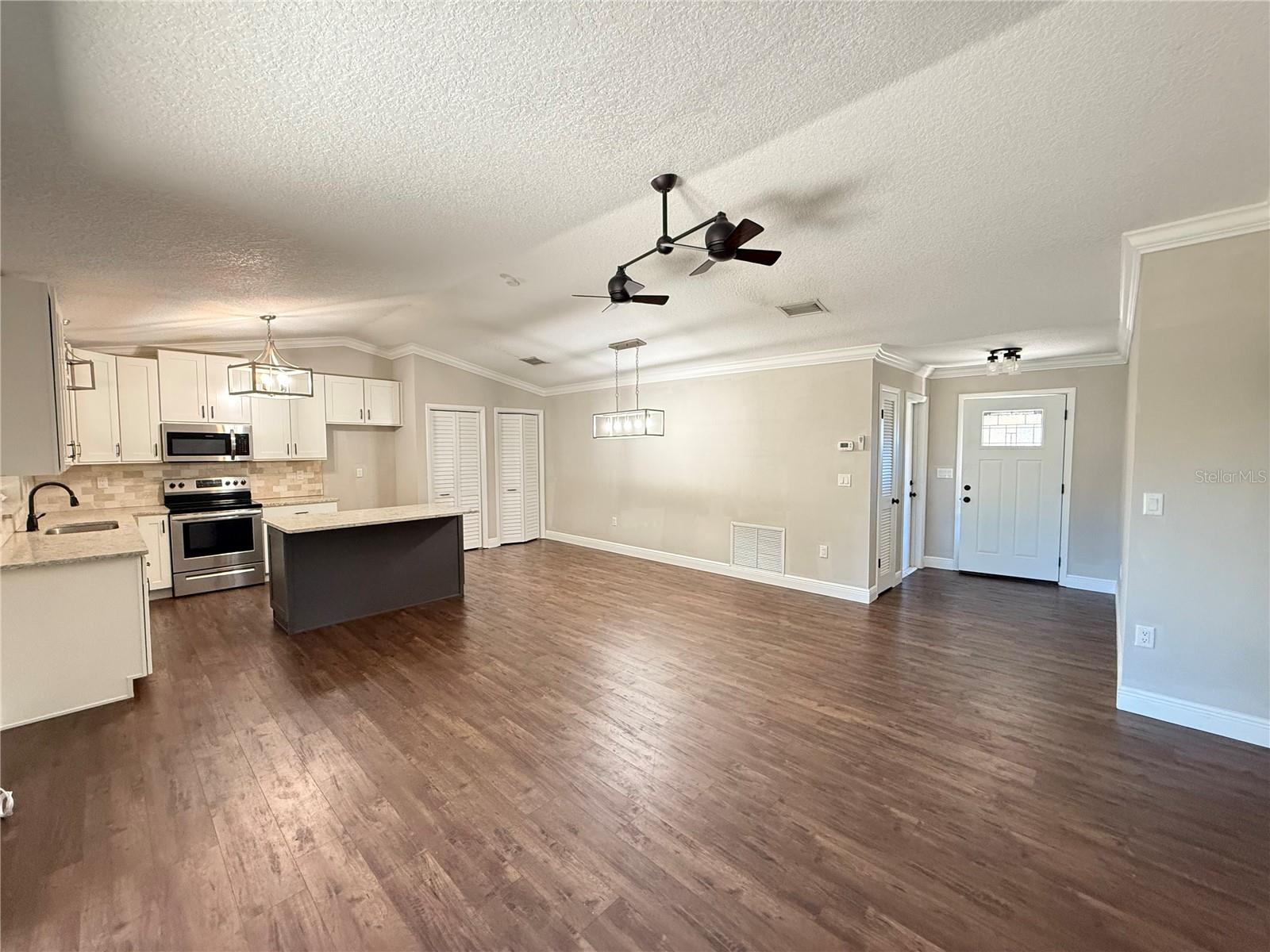 Great Room showing front entry, door to garage and Kitchen.