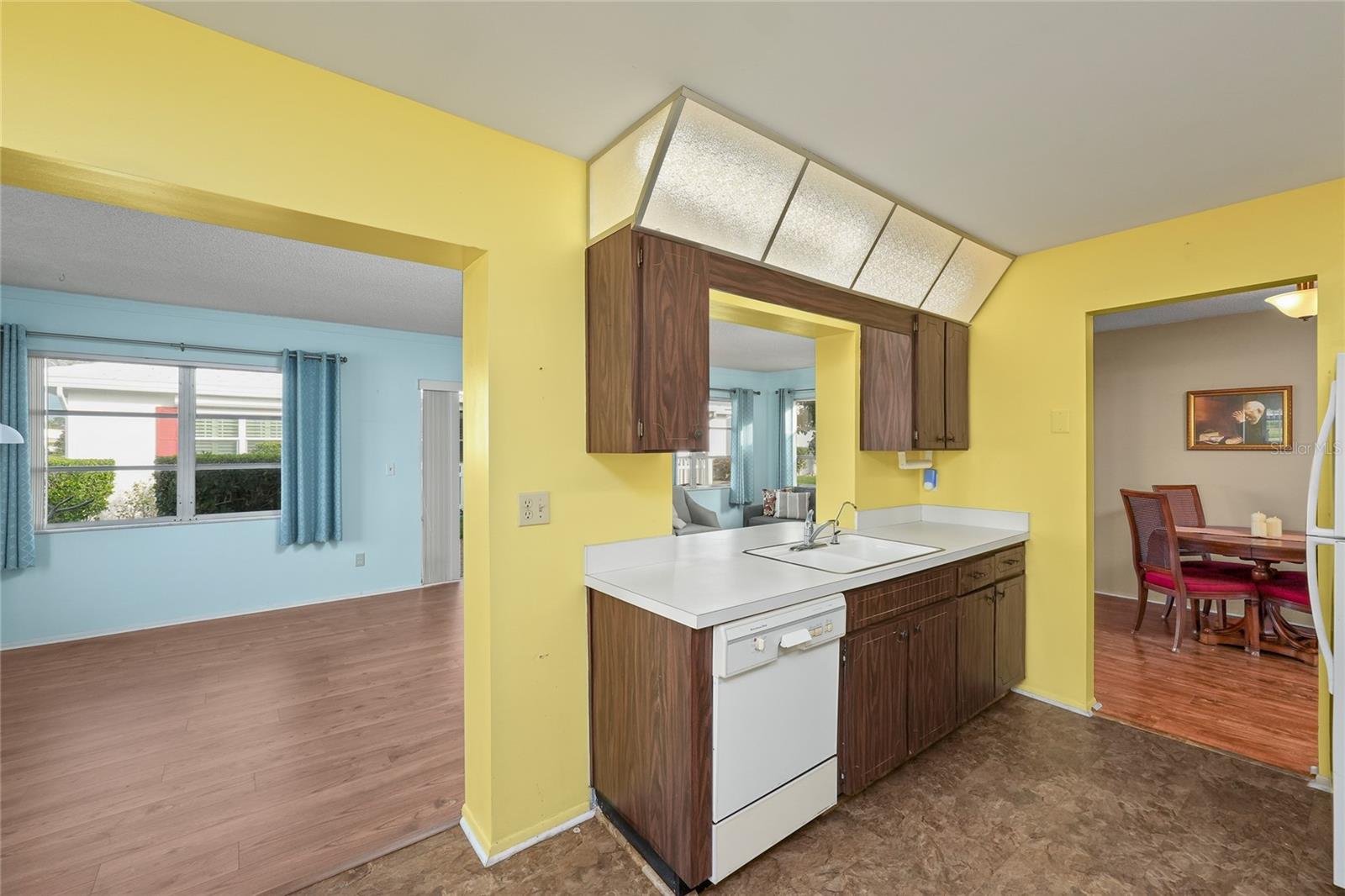 The kitchen is accessible from both the dining area and the Florida room.