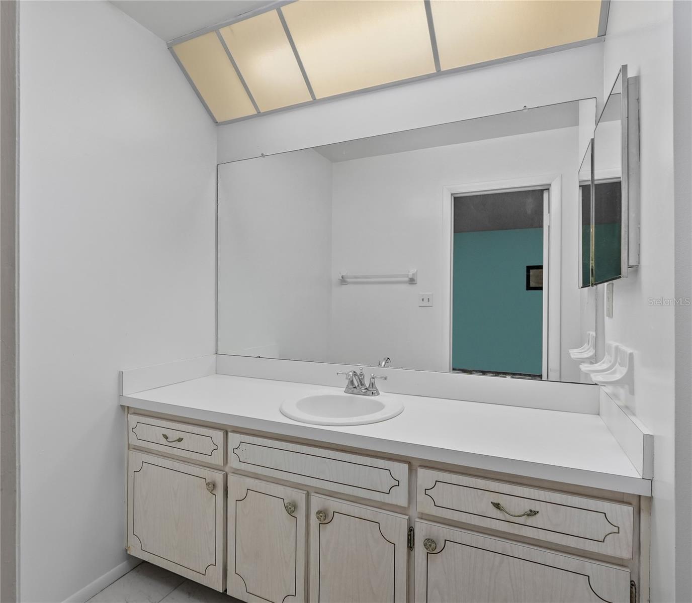 The primary bath has a large vanity with ample counter space.
