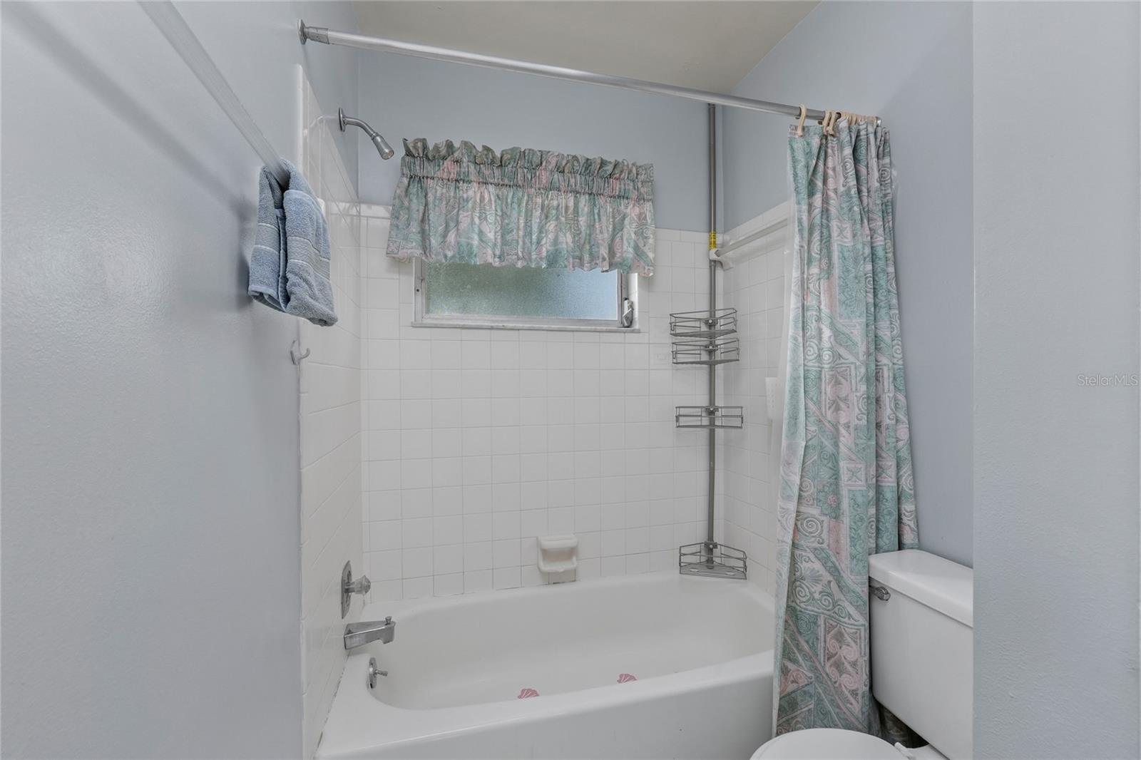 The guest bathroom has a tub/shower combination.
