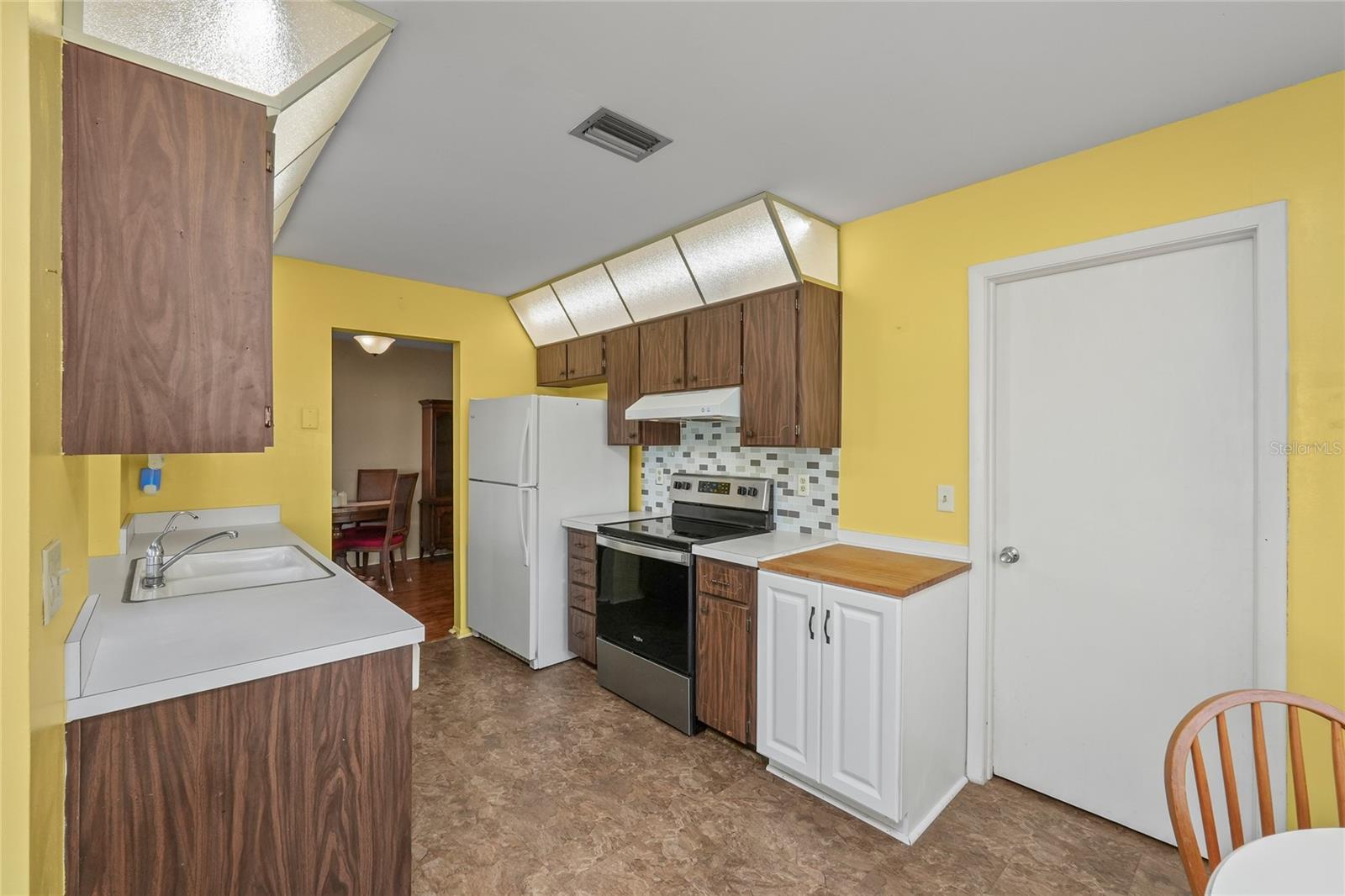 he kitchen space has ample cabinet and storage space and has direct access to the garage.