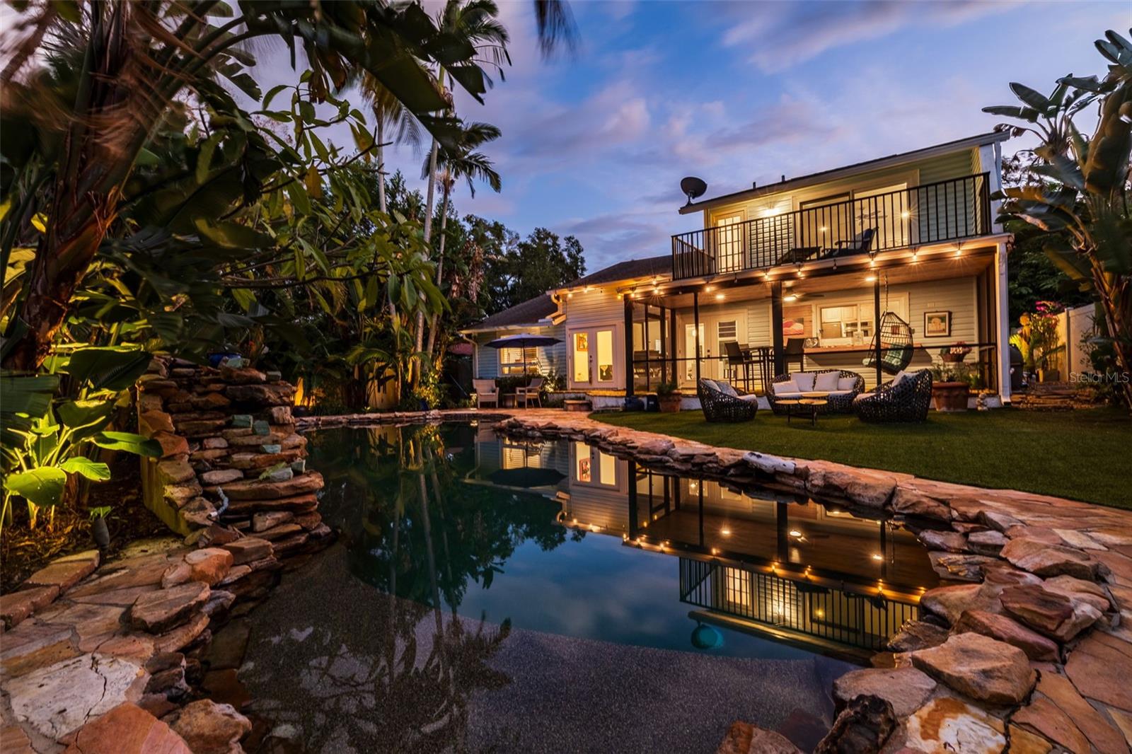 Bali-inspired back yard with heated lagoon-style pool.