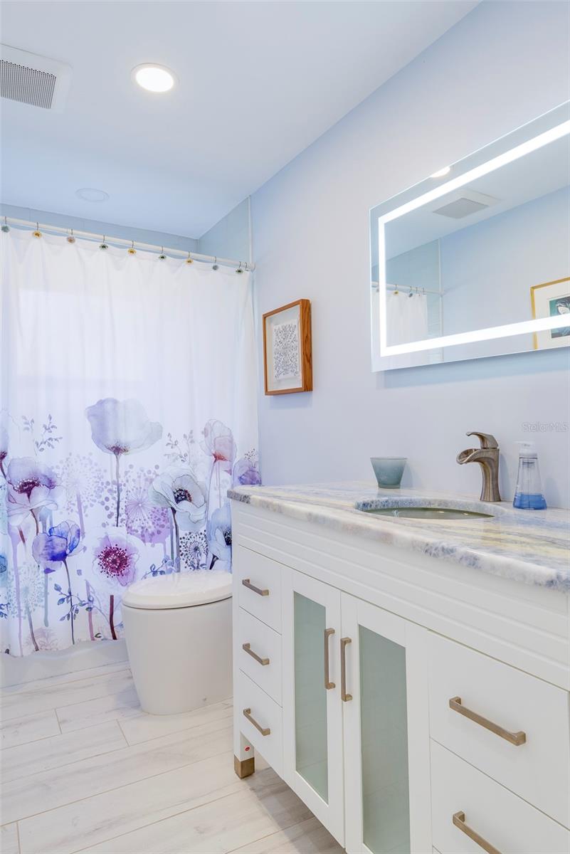 The custom vanity countertop is imported marble from France called “Starry Night” after the Van Gogh painting. The countertop is a work of art in itself.