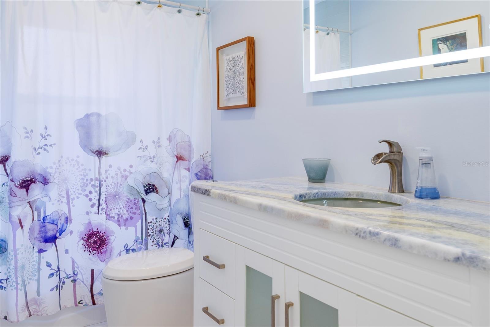 Full hall bath between bedroom 2 and 3.